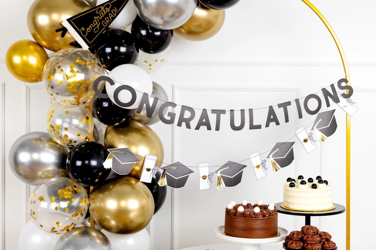 Graduation party setup with Congratulations banner, balloons, and cakes