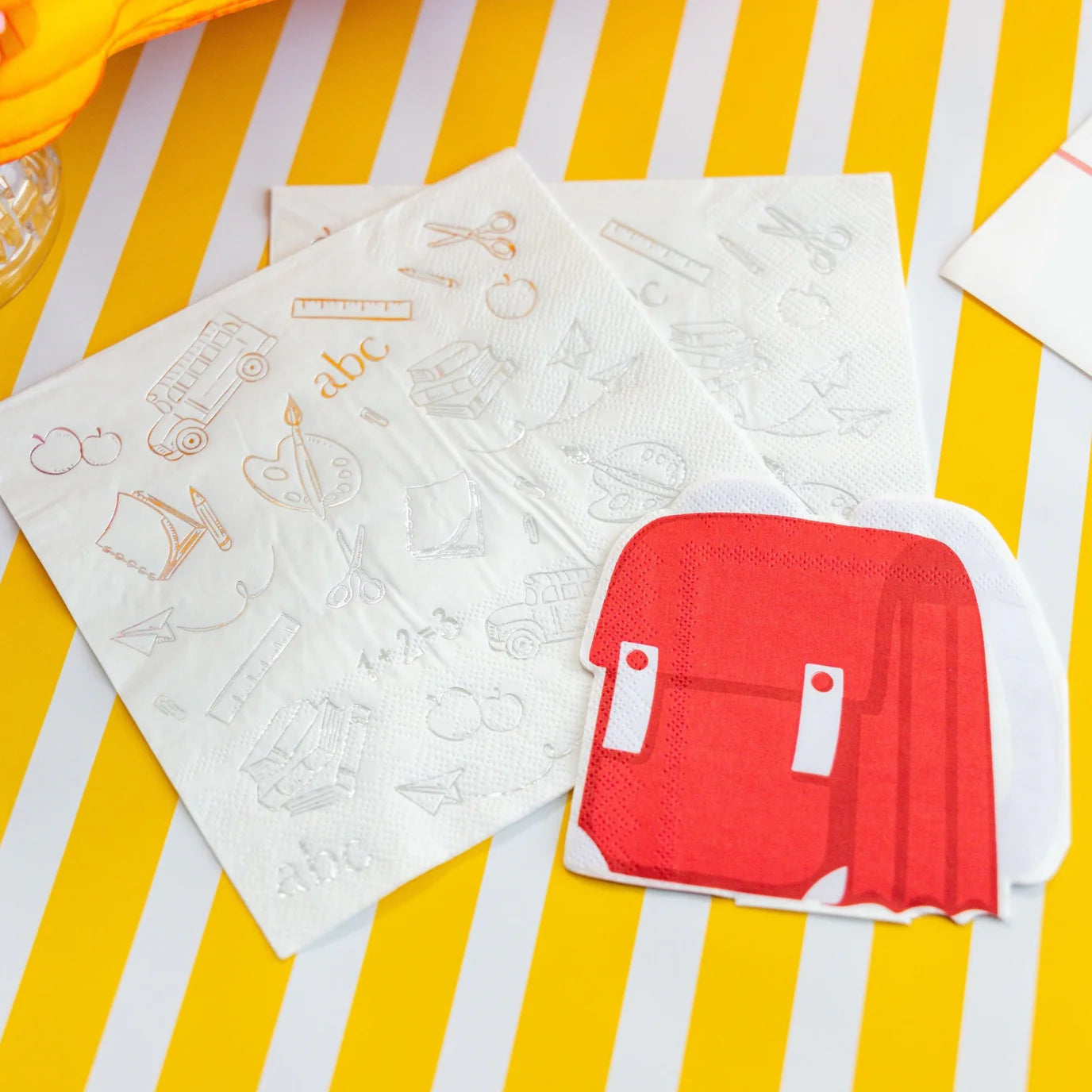 Sunny breakfast table: striped runner, honeycomb apples, waffles, multicolor school plates and cups.