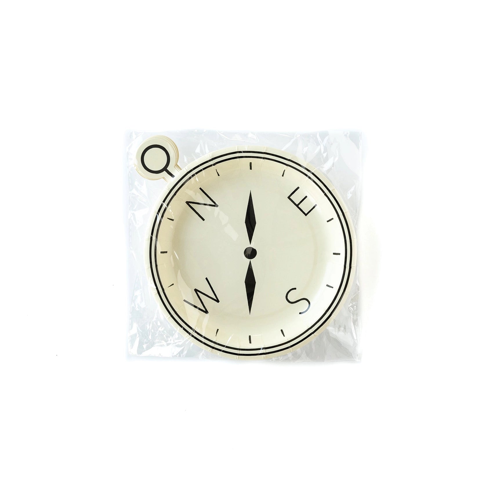 Unwrapped compass-shaped paper plate with black directional lettering and needle, resembling a vintage explorer’s compass.