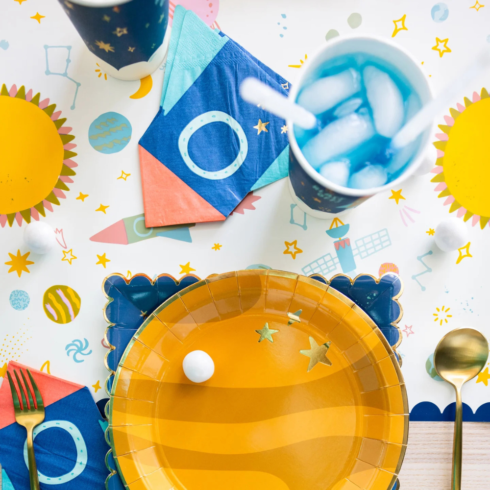 Top view of table runner with blue cup, star-shaped decor, and yellow plate