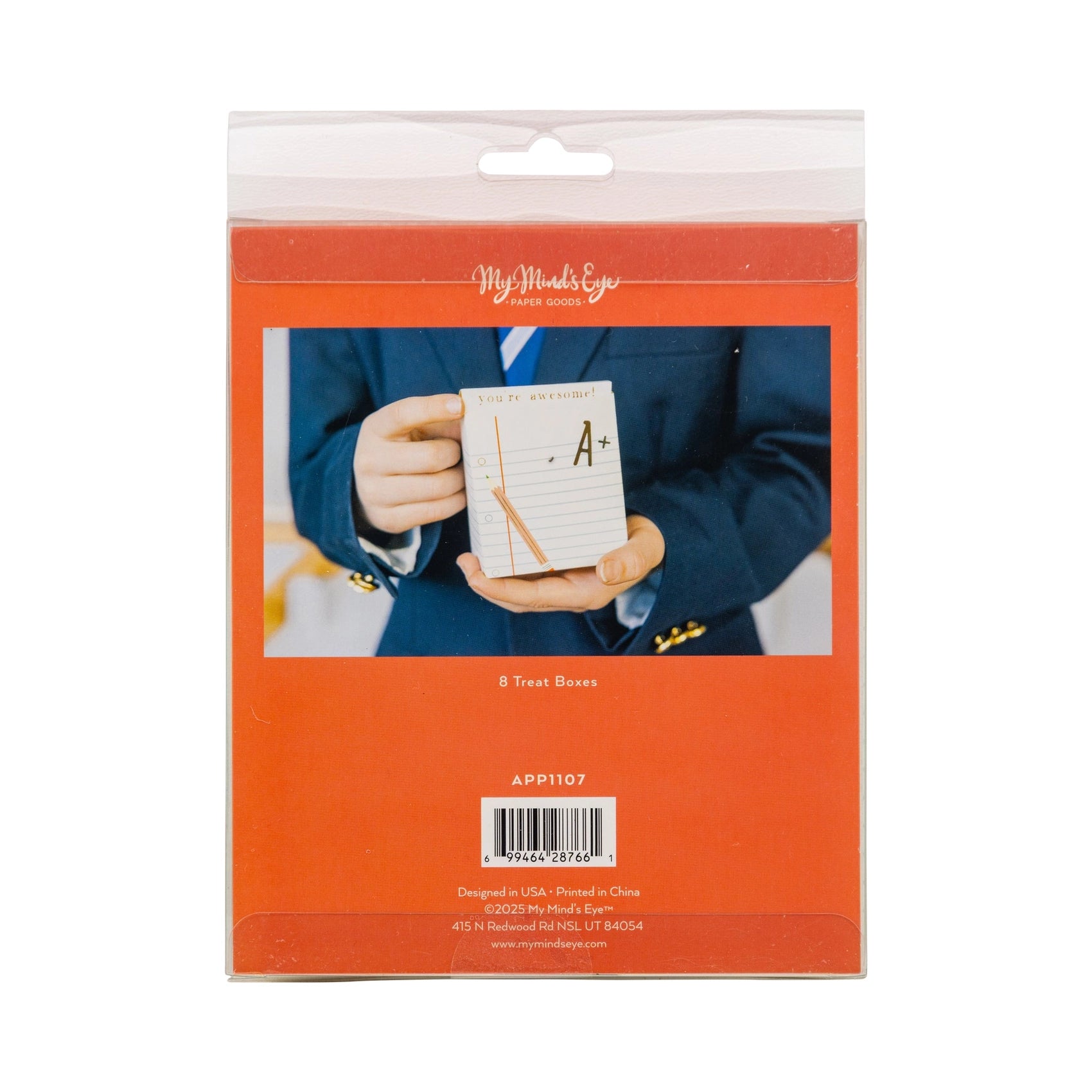 A child in a navy blazer holding the ruled paper treat box with an “A+” and pencil illustration.