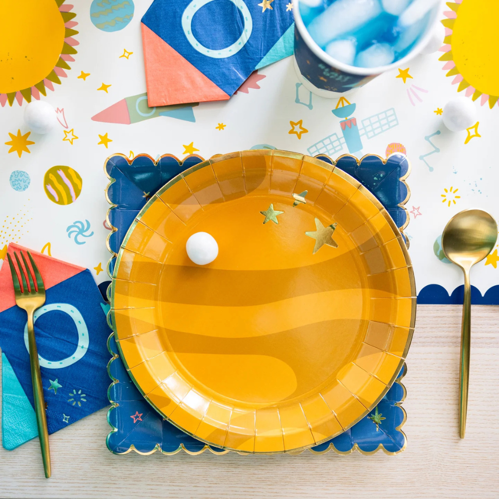 Flat lay of Planet Paper Plate and coordinating space-themed tableware