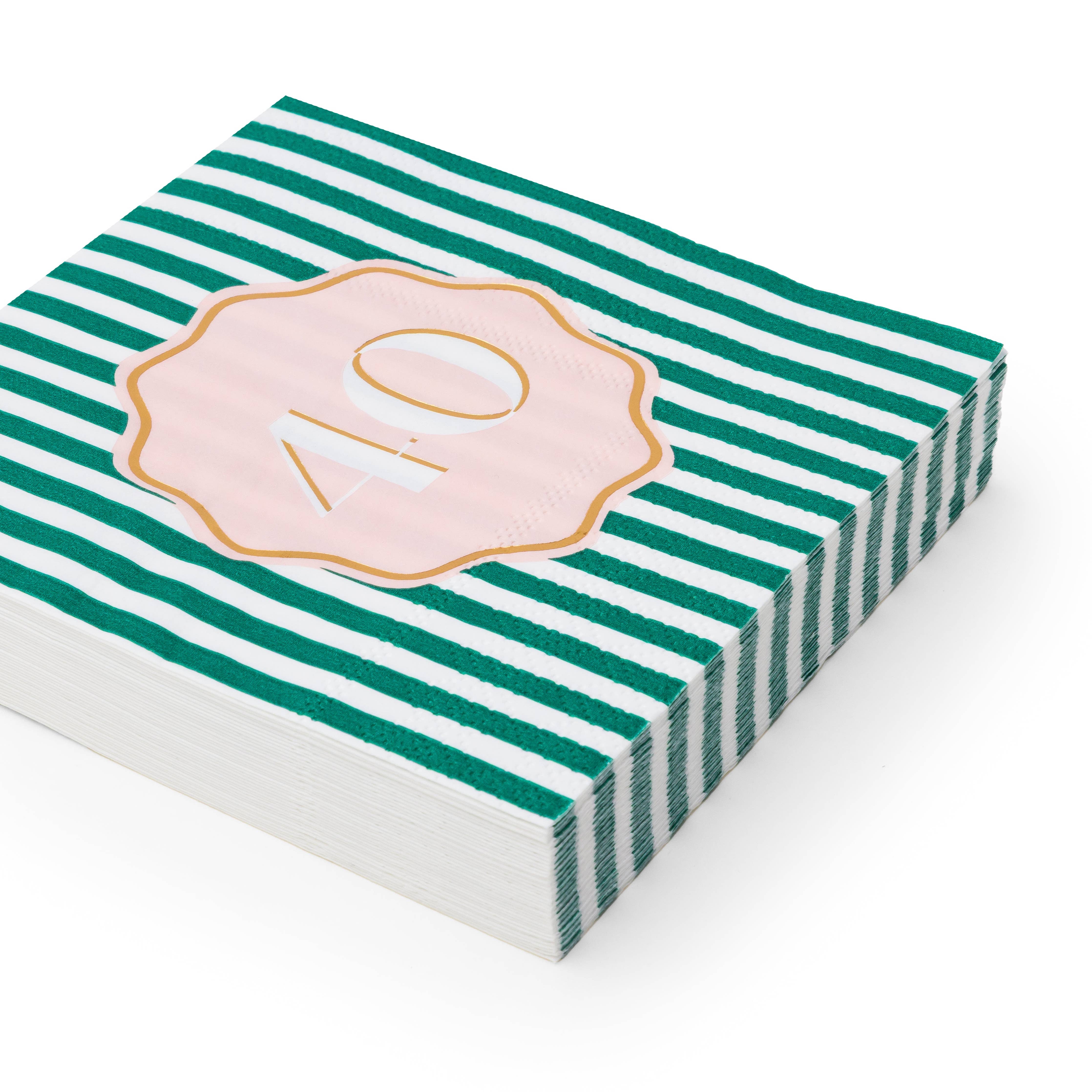 Angled stack of hunter green and white striped 40th birthday cocktail napkins with pink gold foil number 40 scalloped medallion on white background