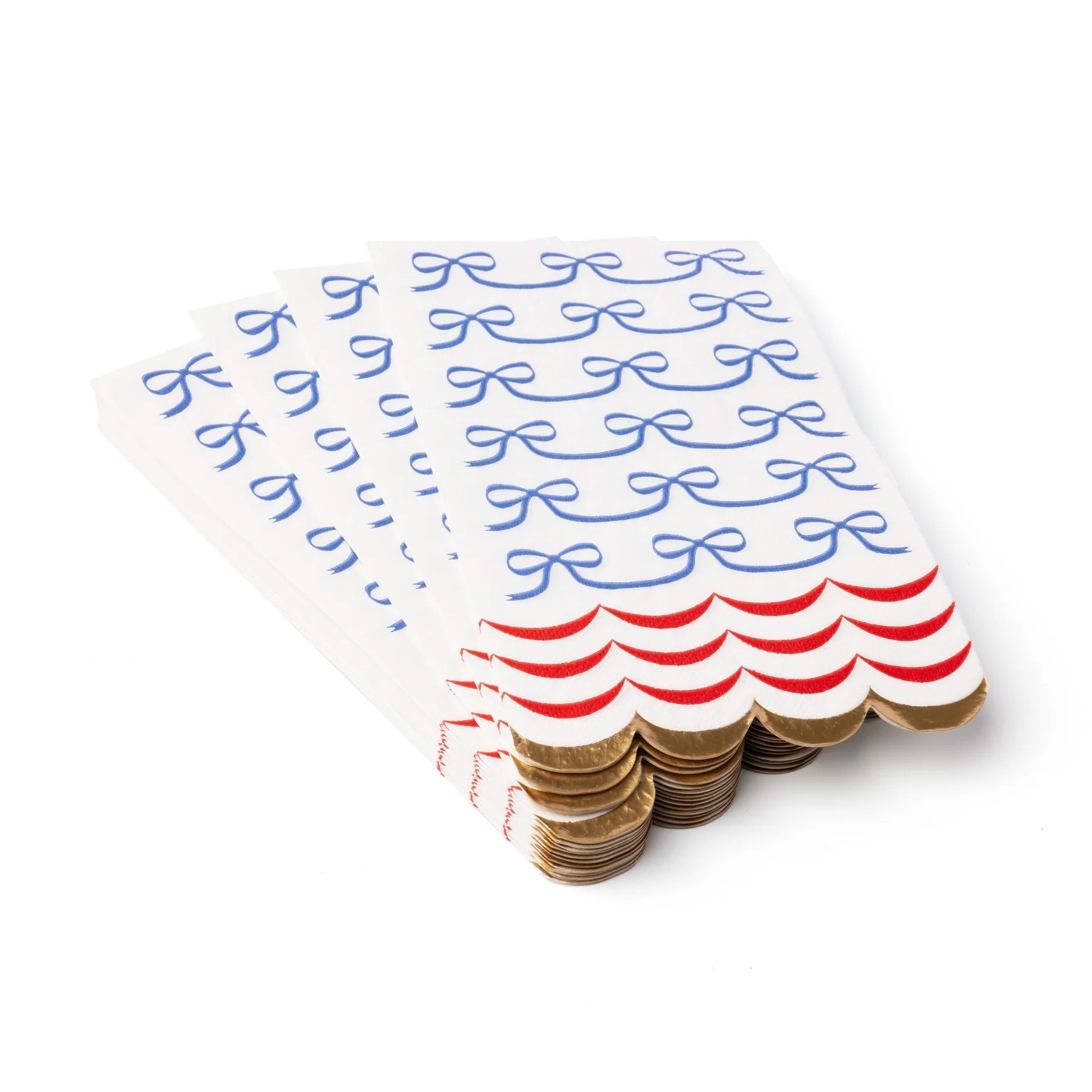 A neatly stacked pile of bow-printed guest towels with gold trim, showing off their elegant scalloped edge and festive red and blue details.