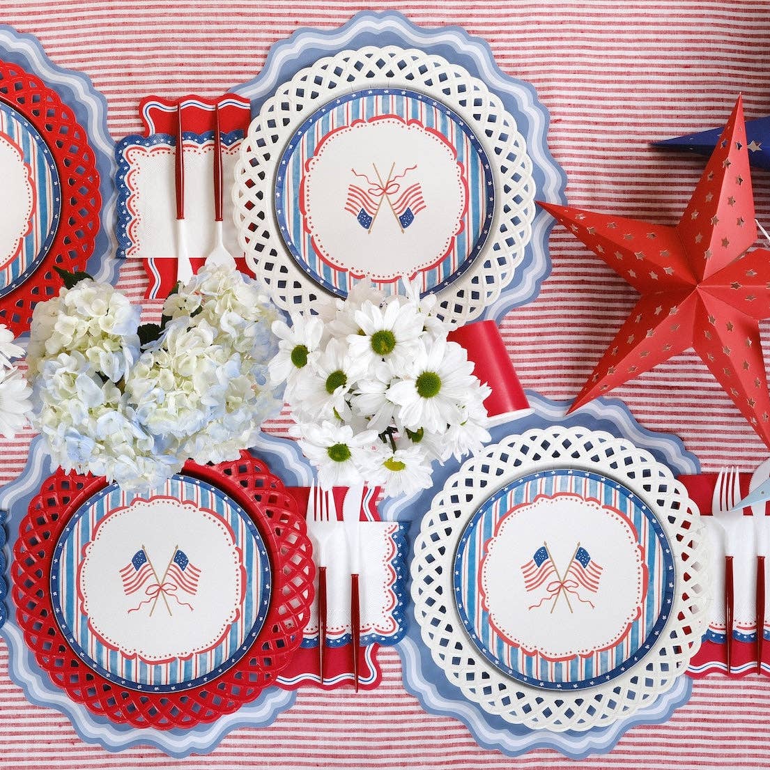 Overhead view of a complete Americana Party Supplies table with Patriotic Cocktail Napkins at every setting.