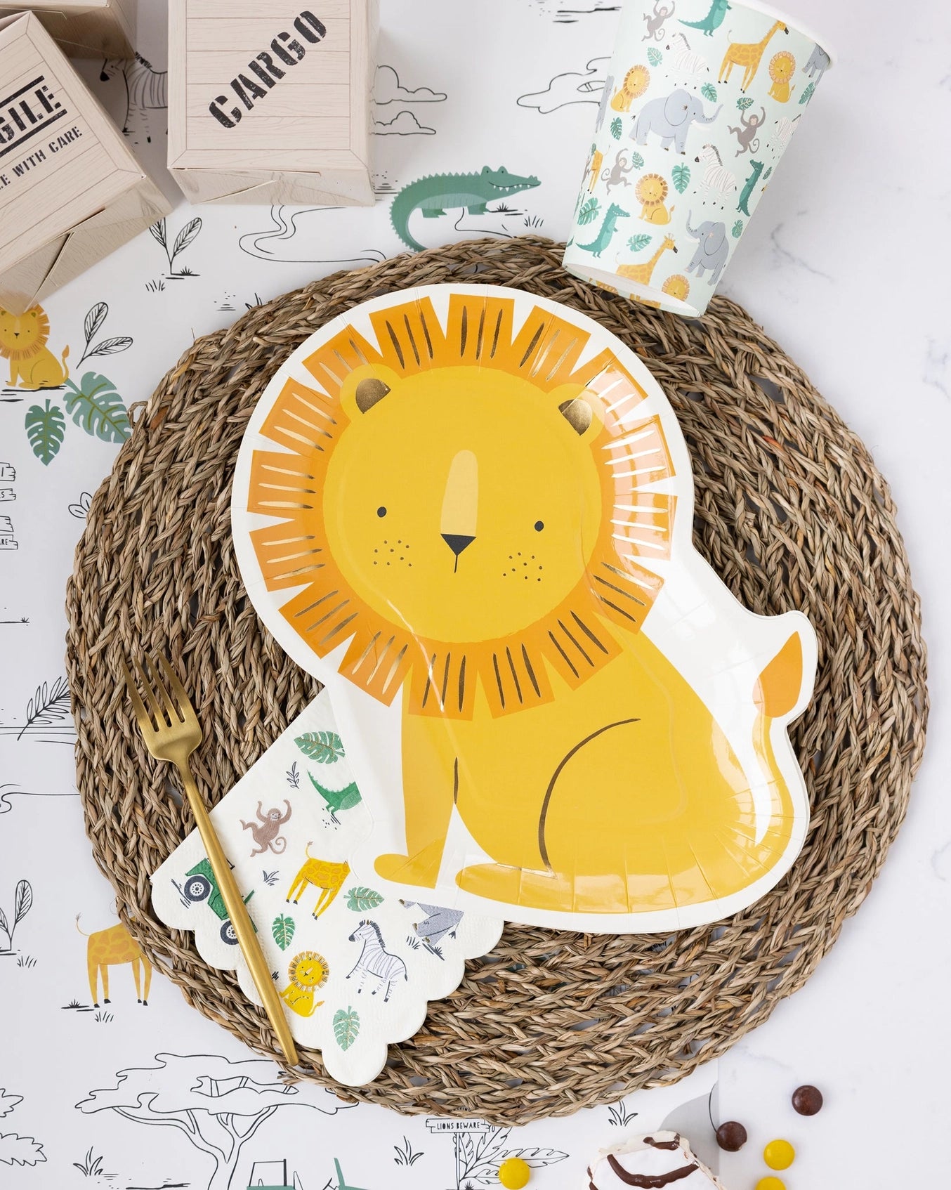 Safari-themed cocktail napkins with cute jungle animals including lions, elephants, zebras, monkeys, crocodiles, and safari jeeps, accented with gold foil details.