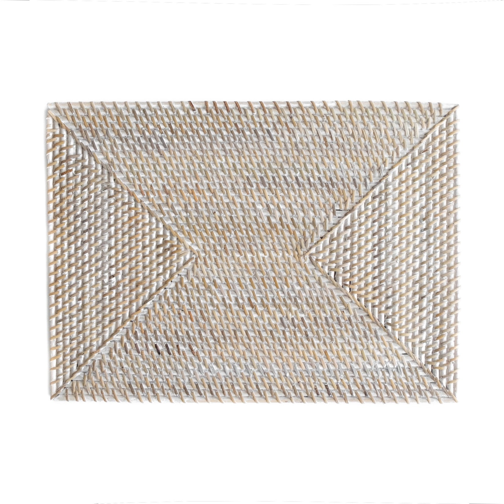 Rectangle rattan placemat in a white wash color on an Spring table. The perfect gift for someone who enjoys hosting.