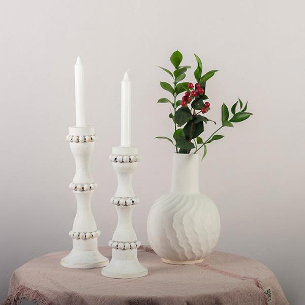 White wooden candle holders that are perfect to use as a centerpiece or throughout the home. These tall candlestick holders are perfect to gift to Mom for Mothers Day