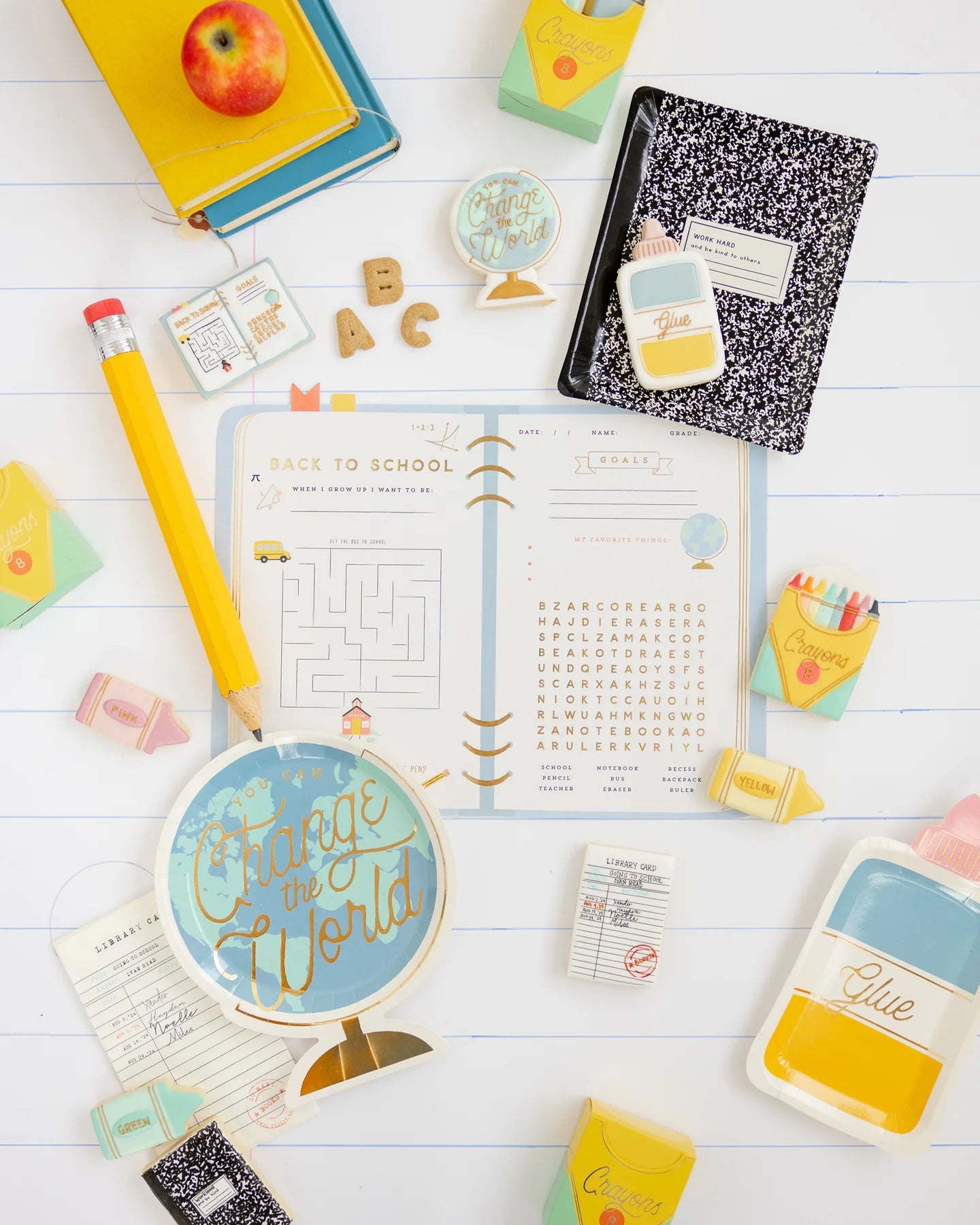 Full party flat-lay with back to school planner placemat, notebooks, cookies, and crayons.