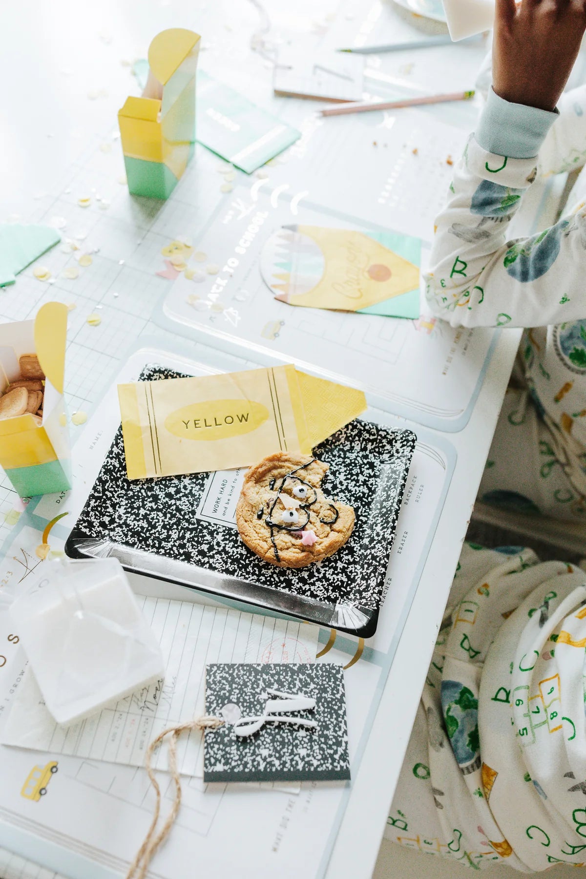 Bright school supply-themed table setting, comp notebook plate used as serving base