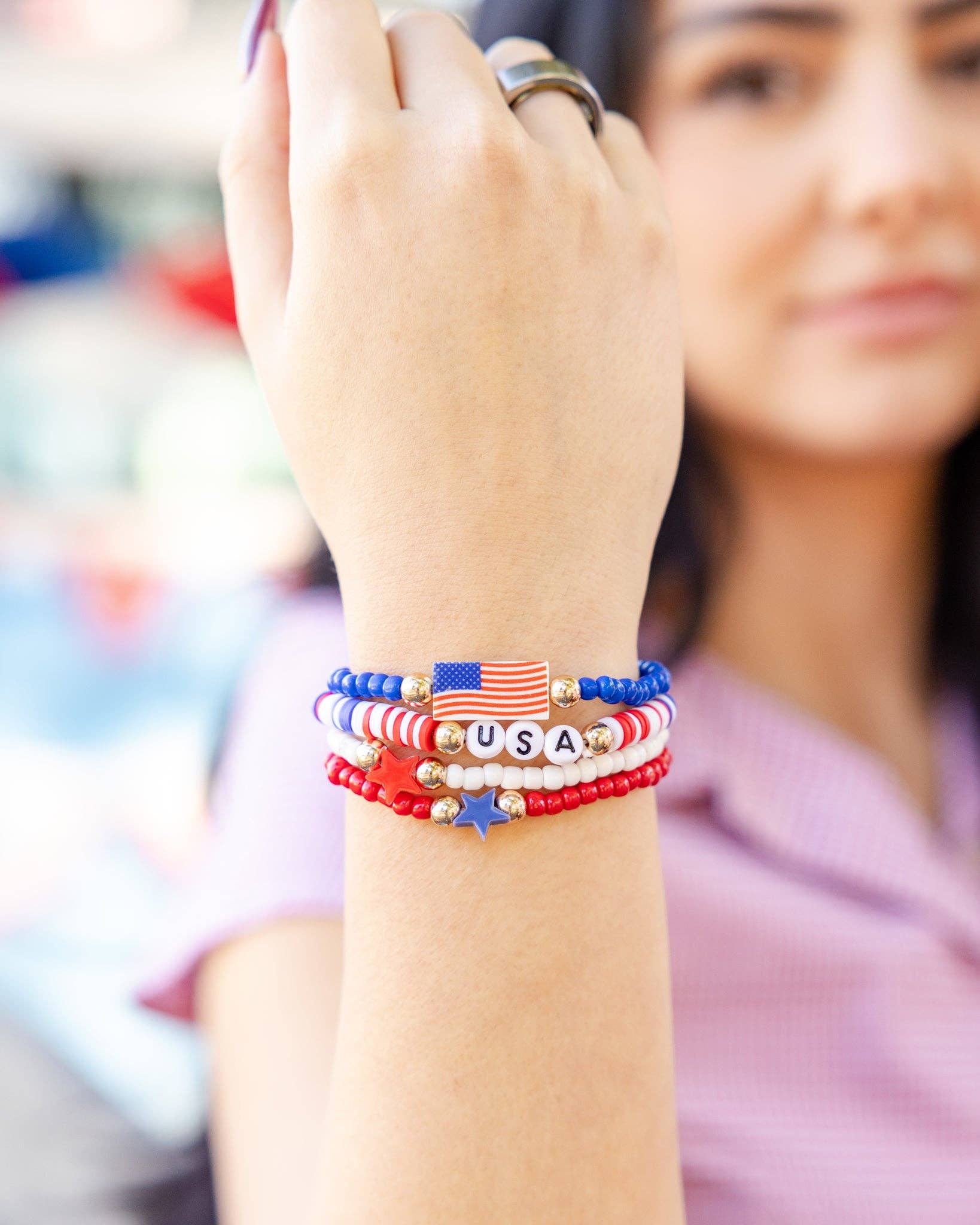 patriotic-bracelet-stack-american-flag-gold-accents-hand-closeup