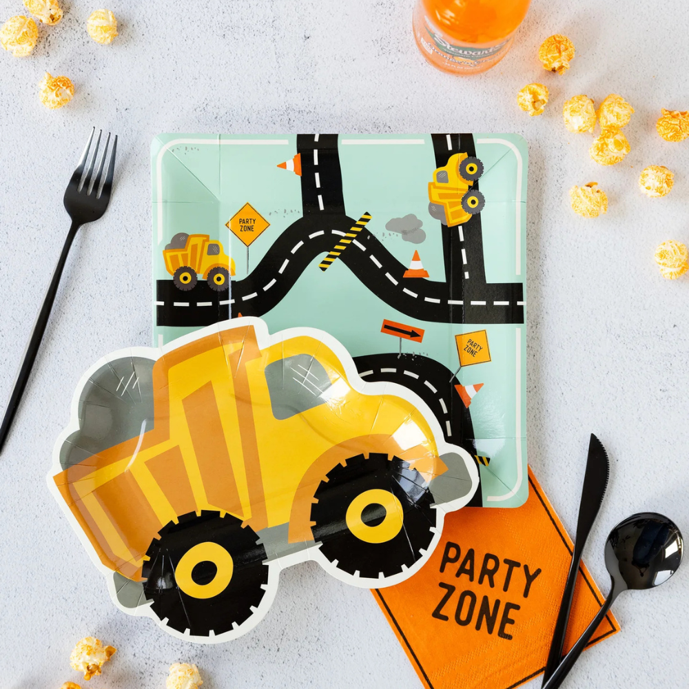 Styled party table with dump truck plate, “Party Zone” napkin, and road plate underneath