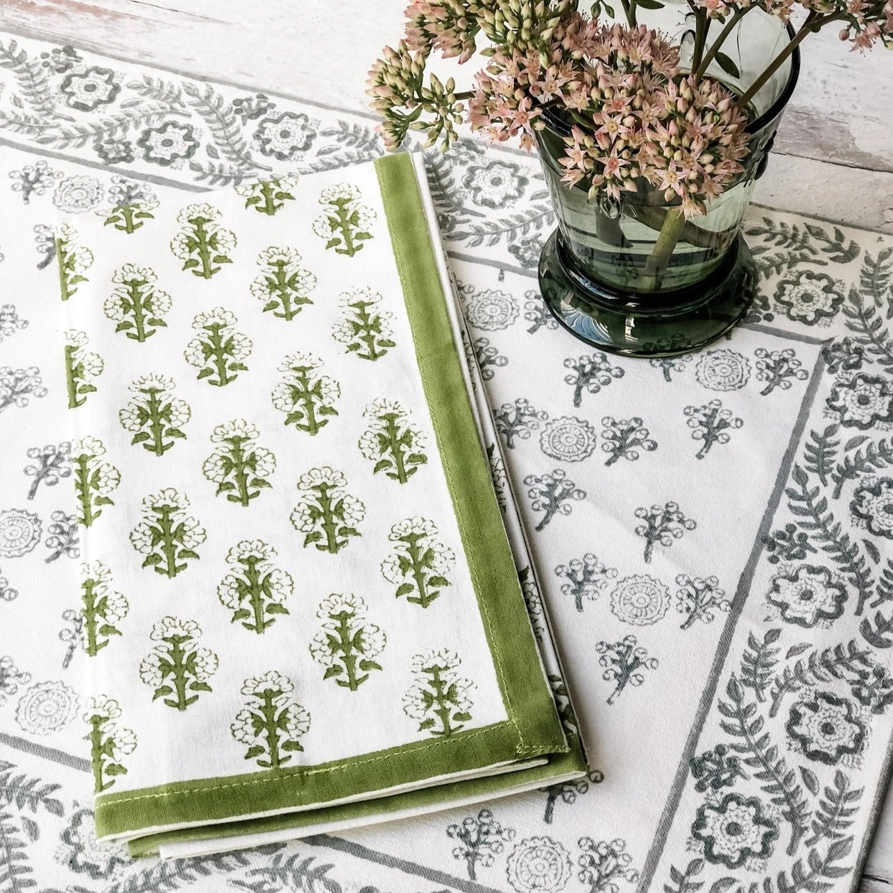 Green cloth napkins with a floral design and matching green border - perfect for a Spring table or Easter tablescape.