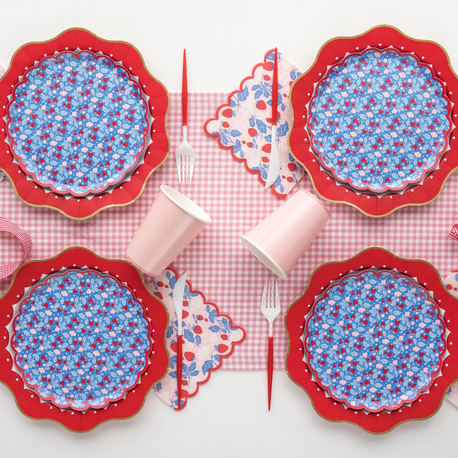 table set with strawberry paper plates