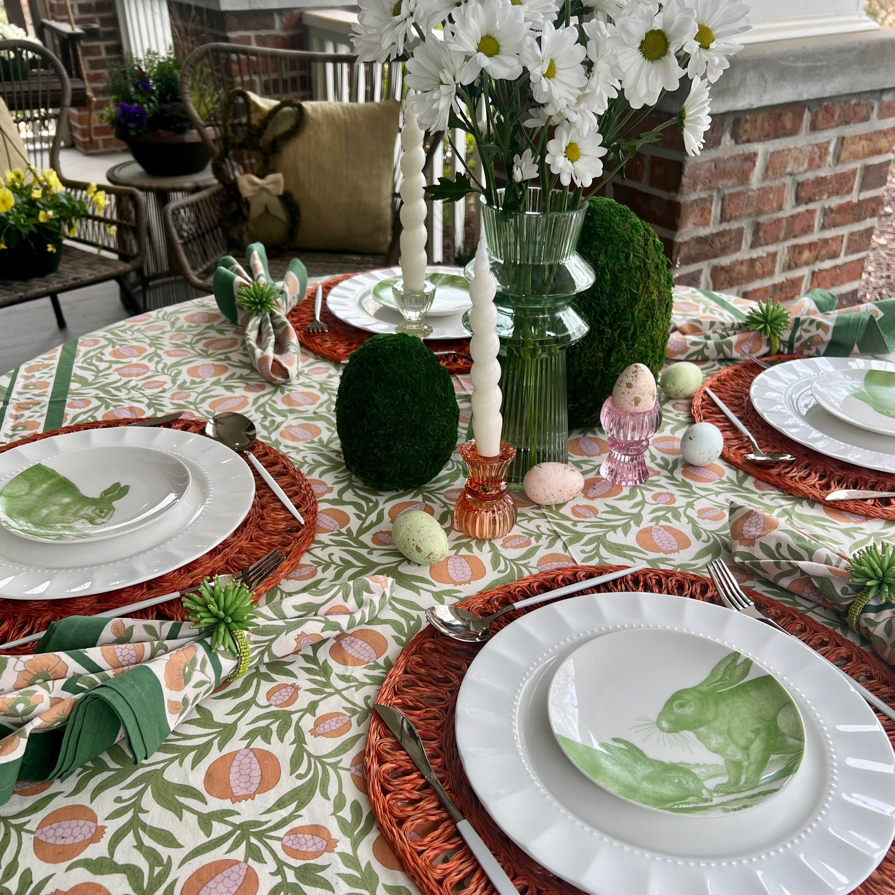 White ceramic appetizer plates with green bunny designs.
