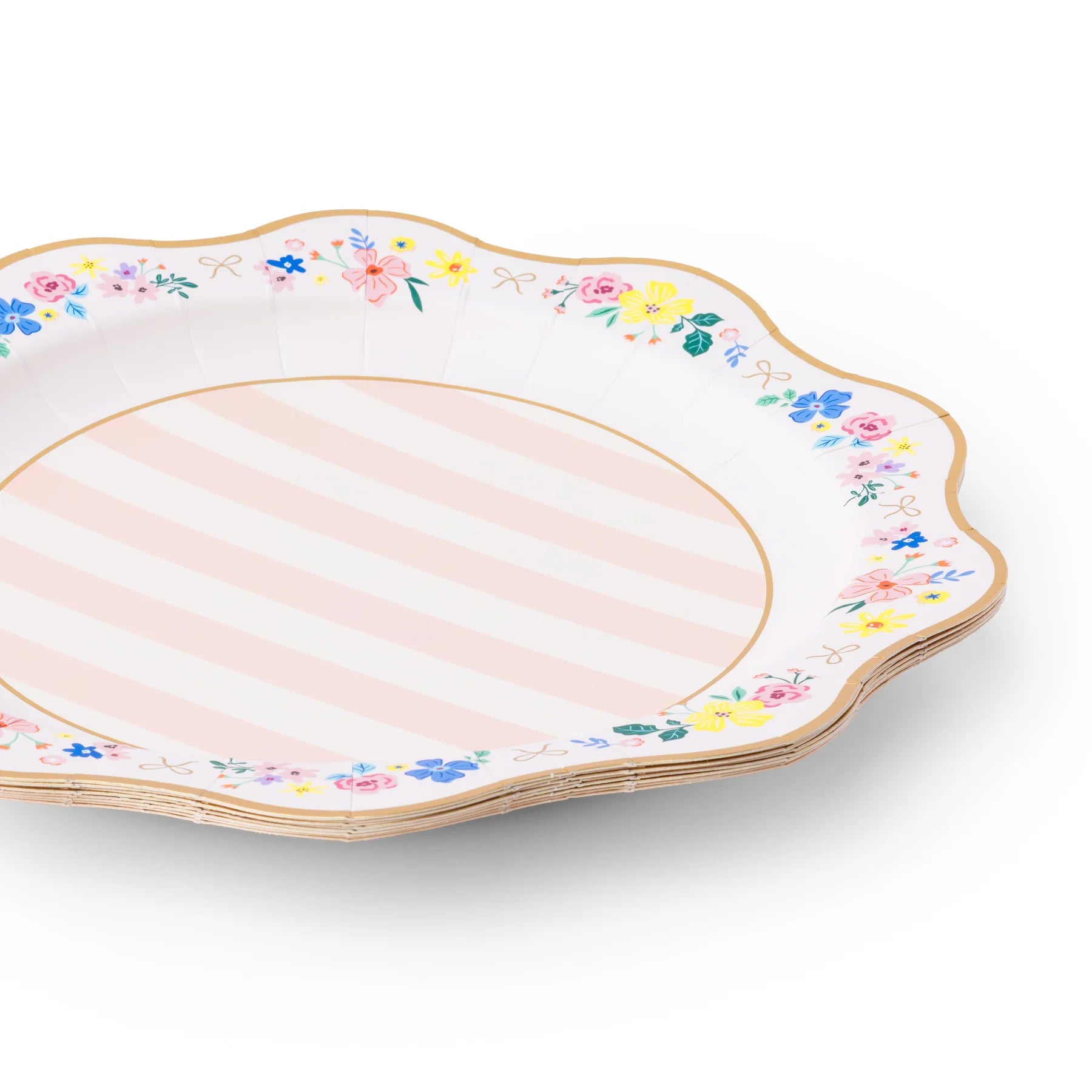 Angled stack of multicolor floral scalloped paper dinner plates with pink stripe center and gold foil rim on white background