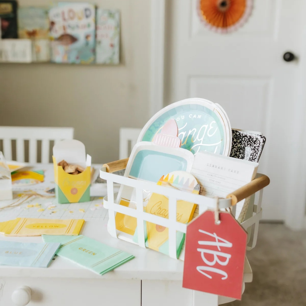 Back to school party table with themed napkins, plates, and school supply-inspired decor in a bright, kid-friendly setup.
