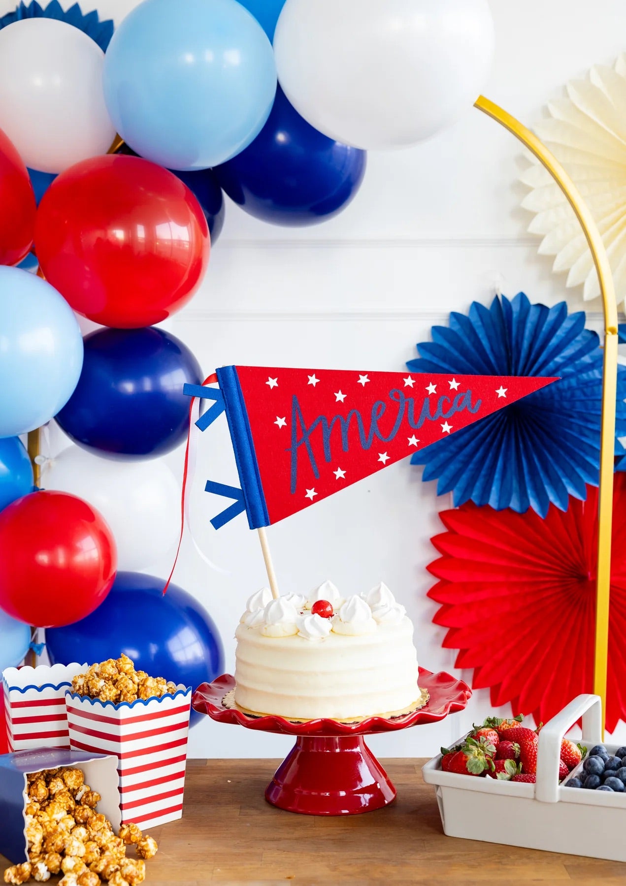Felt America pennant used as a playful cake topper at a Fourth of July party.