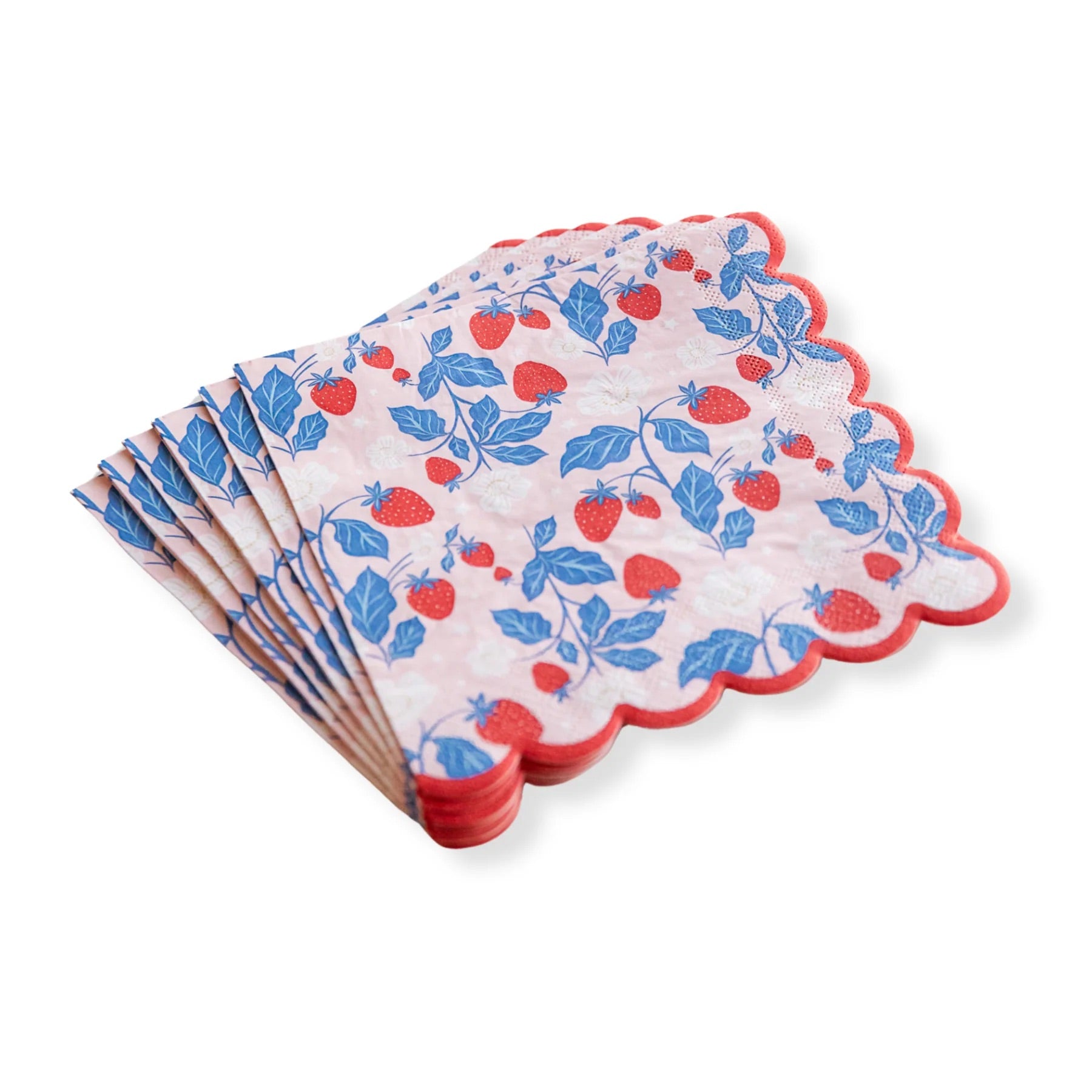 A neatly stacked set of strawberry paper napkins, showing off the delicate print and scalloped edges.