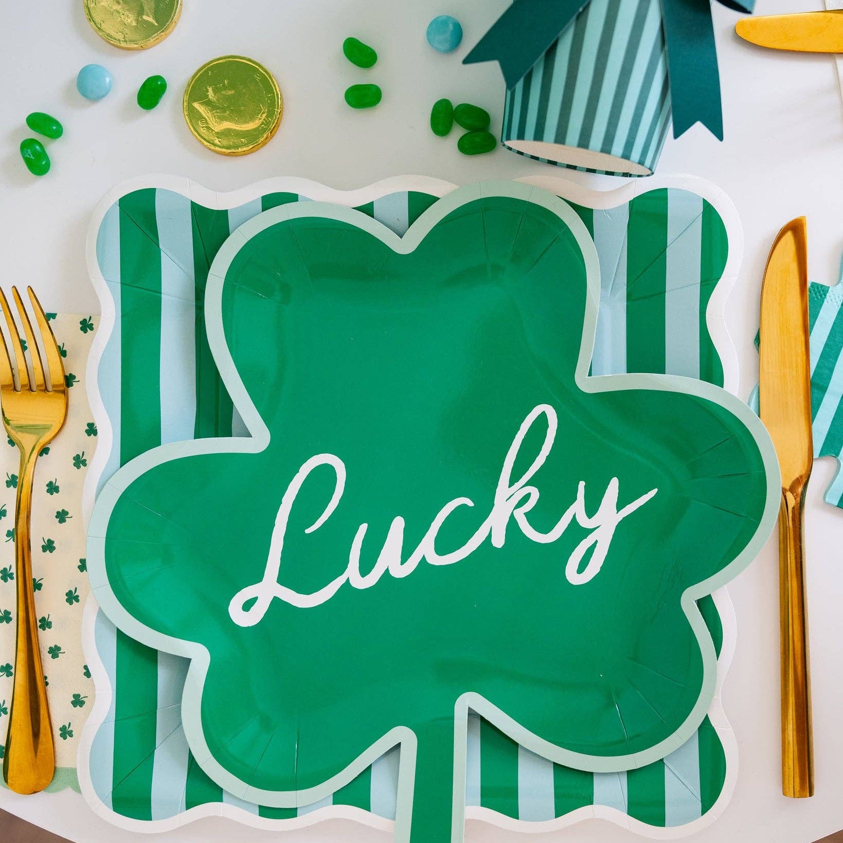 St. Patrick’s Day table setting with green scalloped square plates