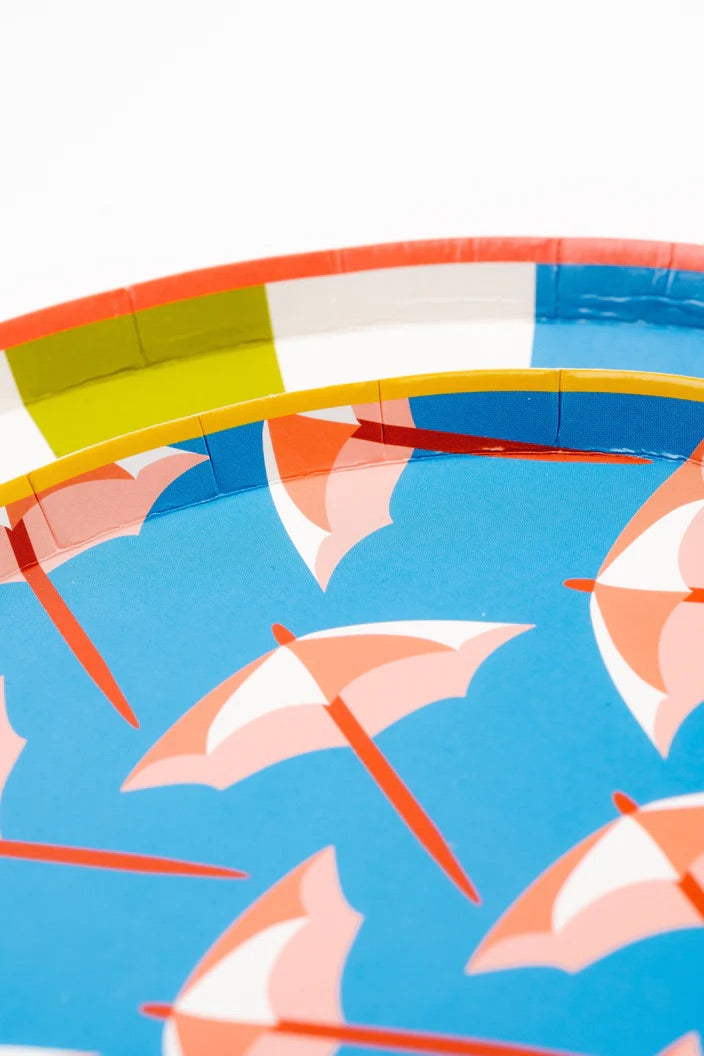 Close-up of a rainbow-striped dinner plate, showing the fun and playful colors.