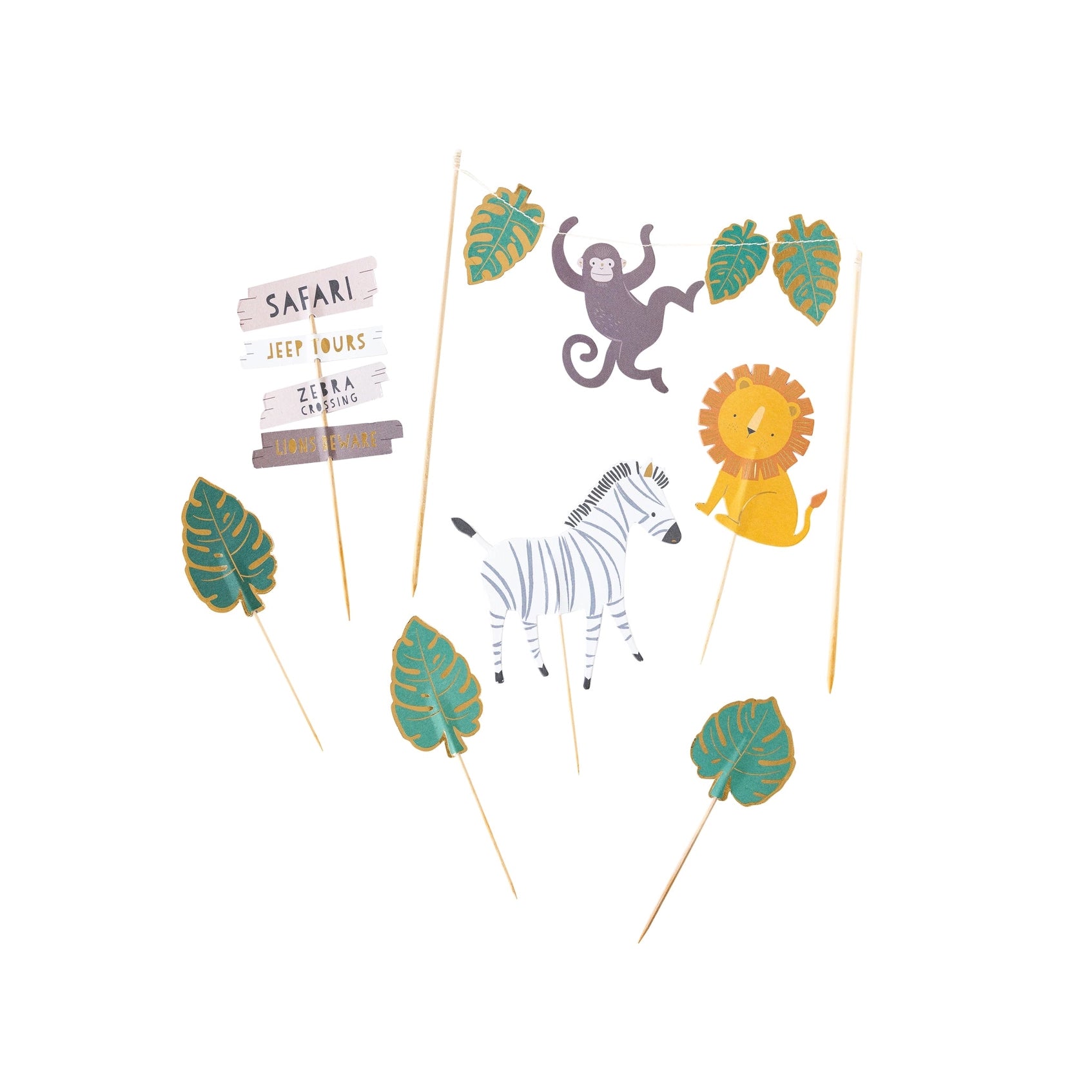 Individual jungle-themed cake toppers laid out separately, including lion, zebra, monkey, leaves, and safari-themed sign.
