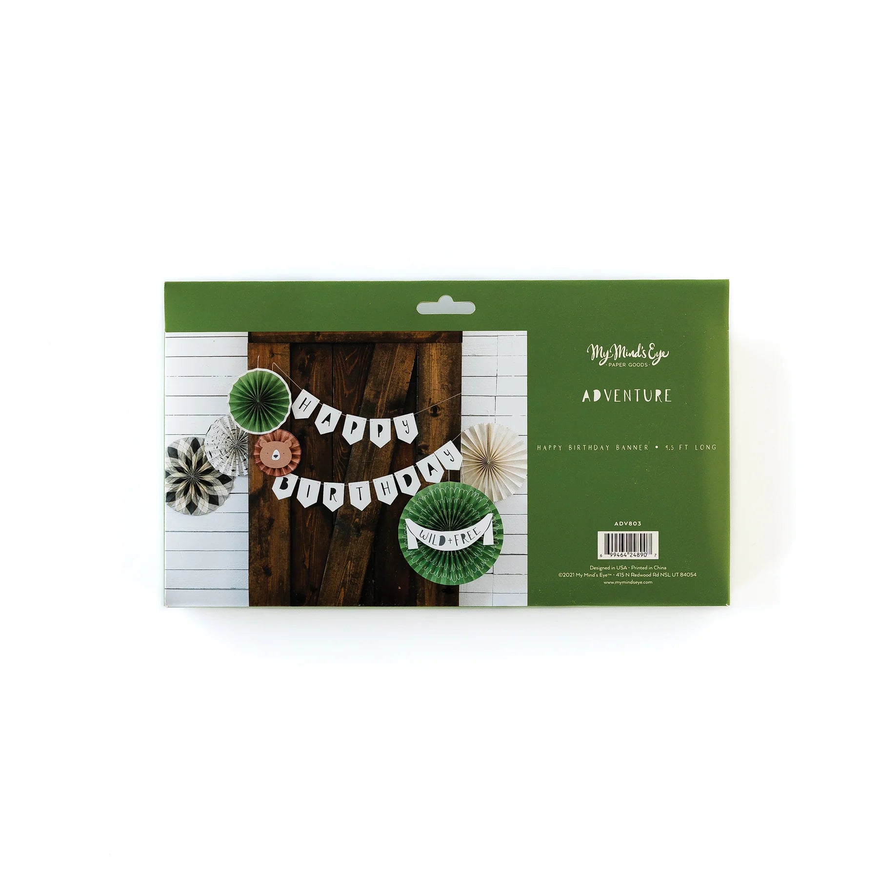 Adventure Happy Birthday Banner in green packaging, showing a rustic wall styled with paper fans and bold “Happy Birthday” sign.