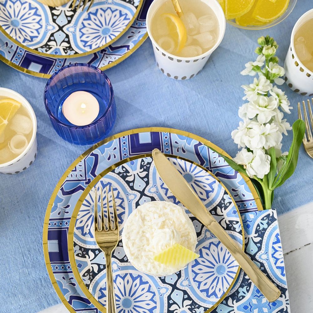 Mediterranean style party table with blue tile plates and summer drinks.
