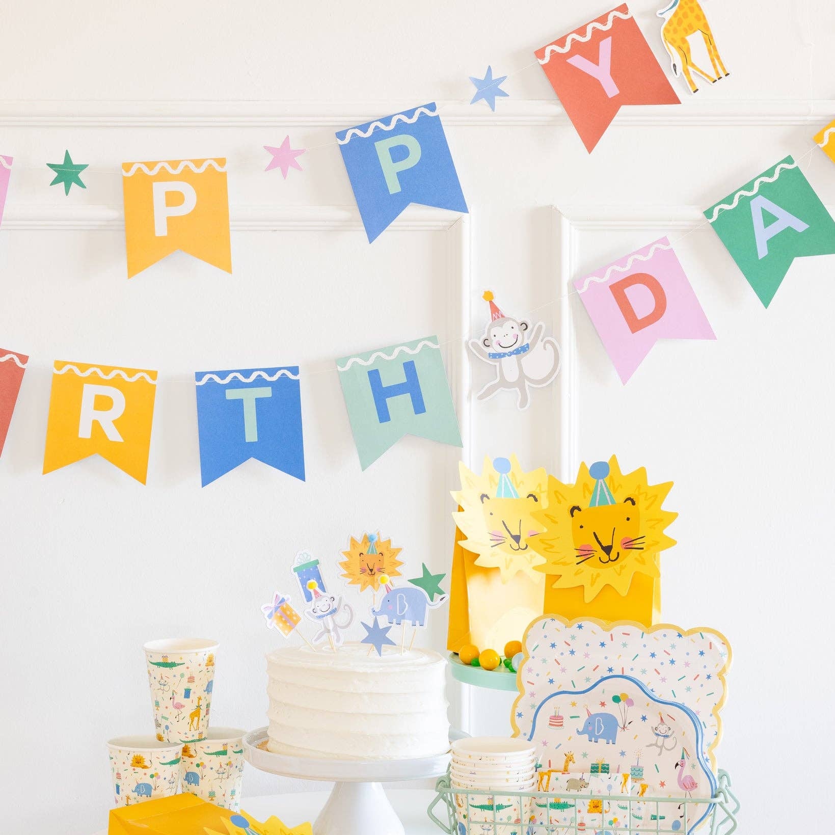 Close view of animal birthday banner hung across wall party backdrop.