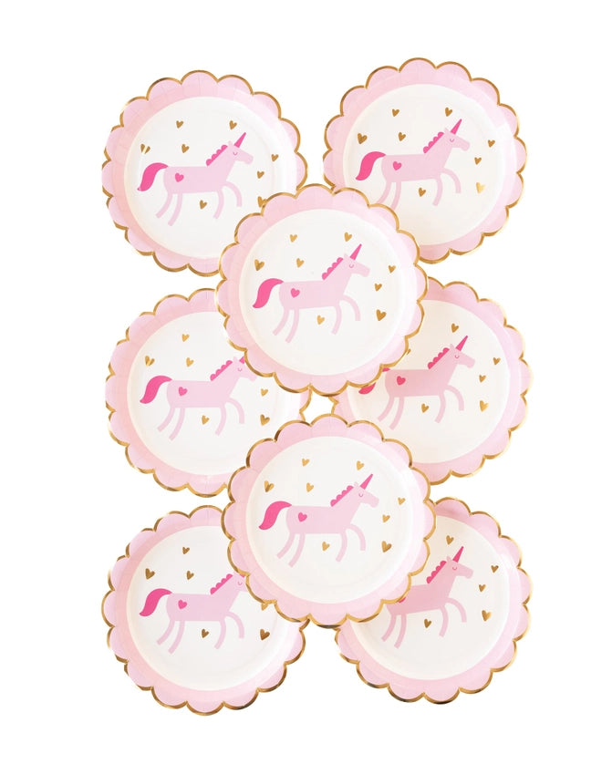 Stack of eight scalloped unicorn birthday party plates with gold foil edge.