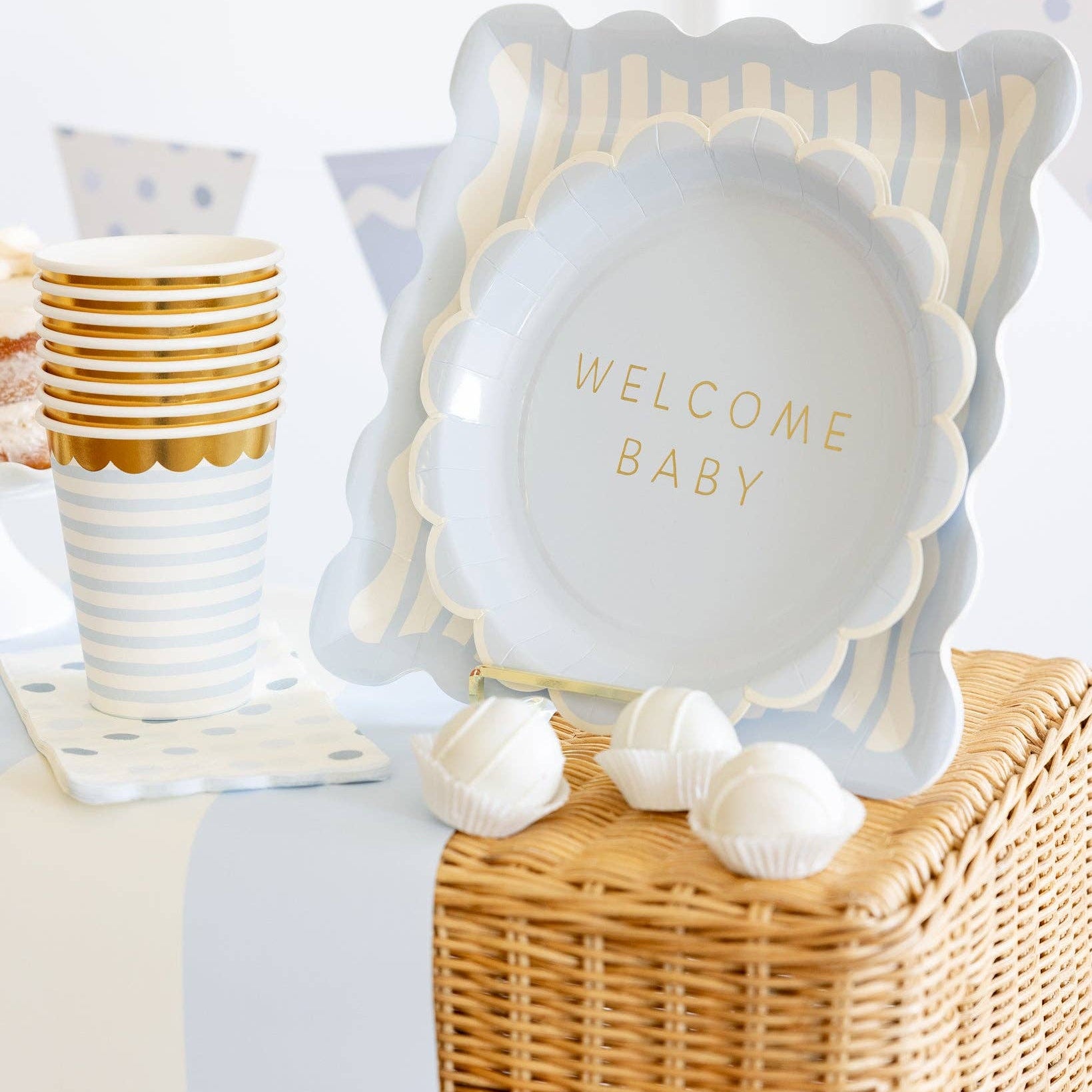 Stack of baby blue party cups styled on a baby shower table