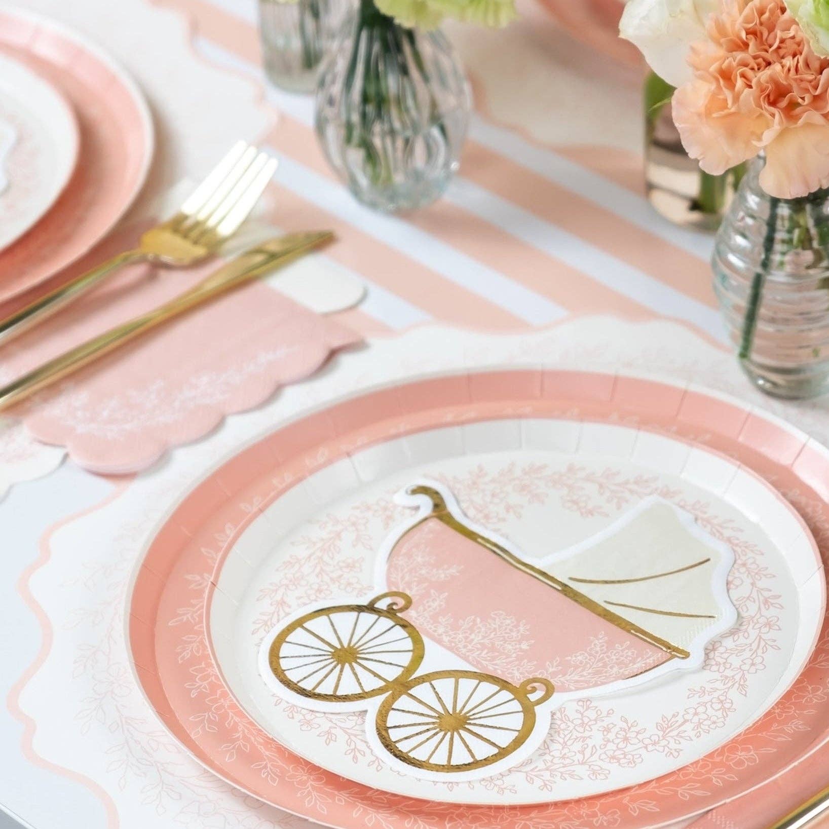 Pink striped table runner with carriage plate and gold utensils