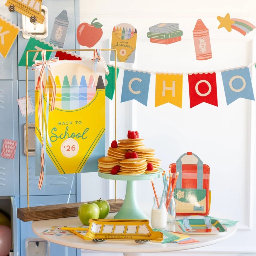 Full back to school party setup with backpack plates and decorations.