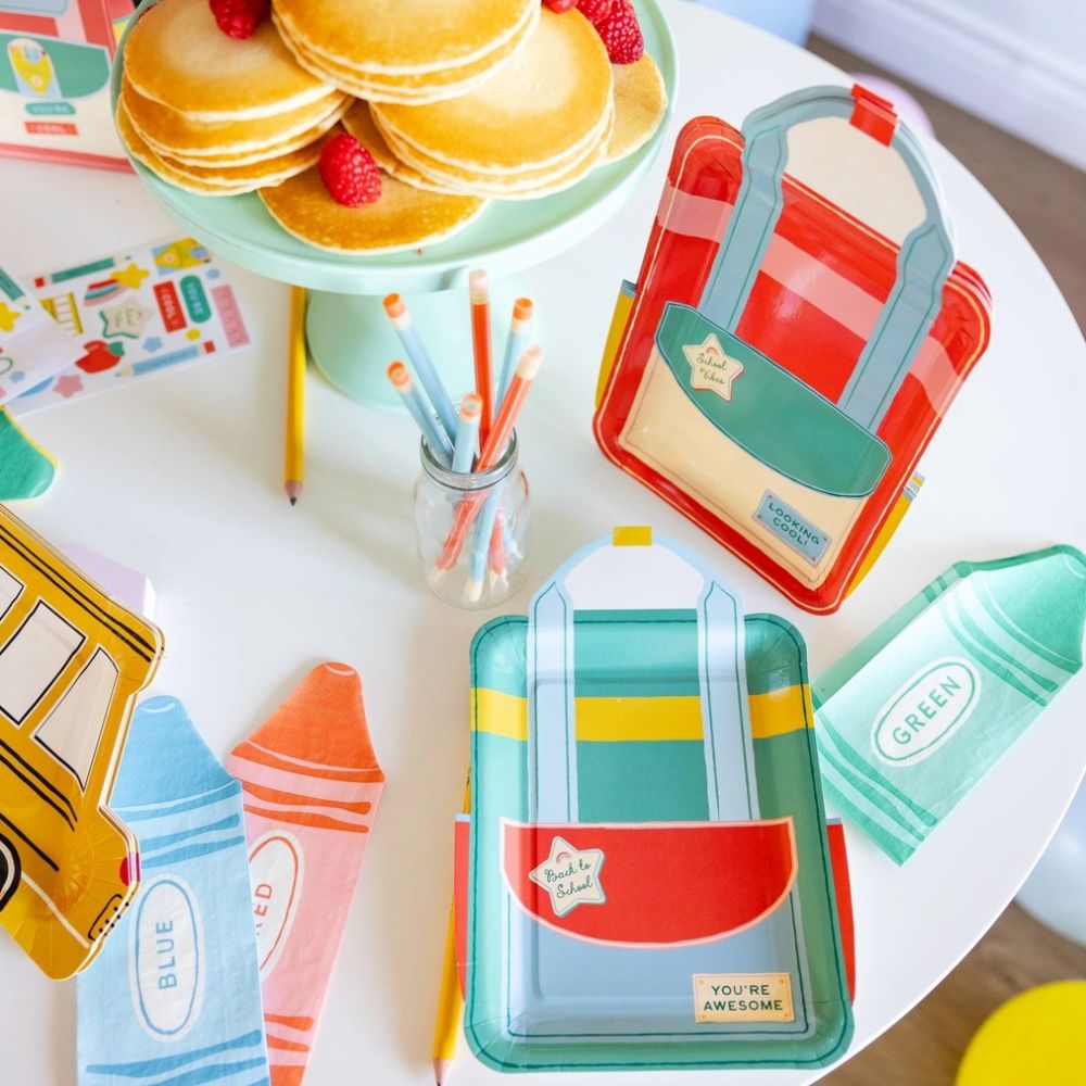 Backpack plate set displayed with back to school party setup.
