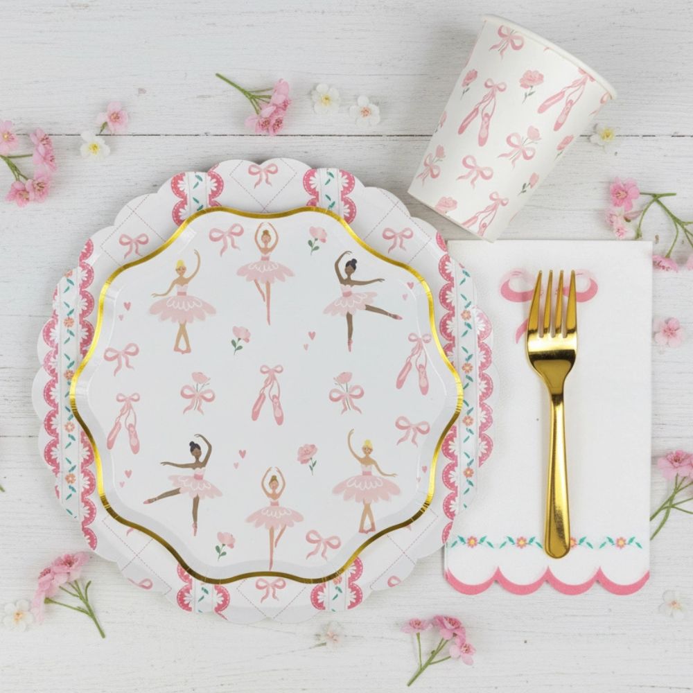 Place setting featuring a ballerina cup next to a gold-edged plate
