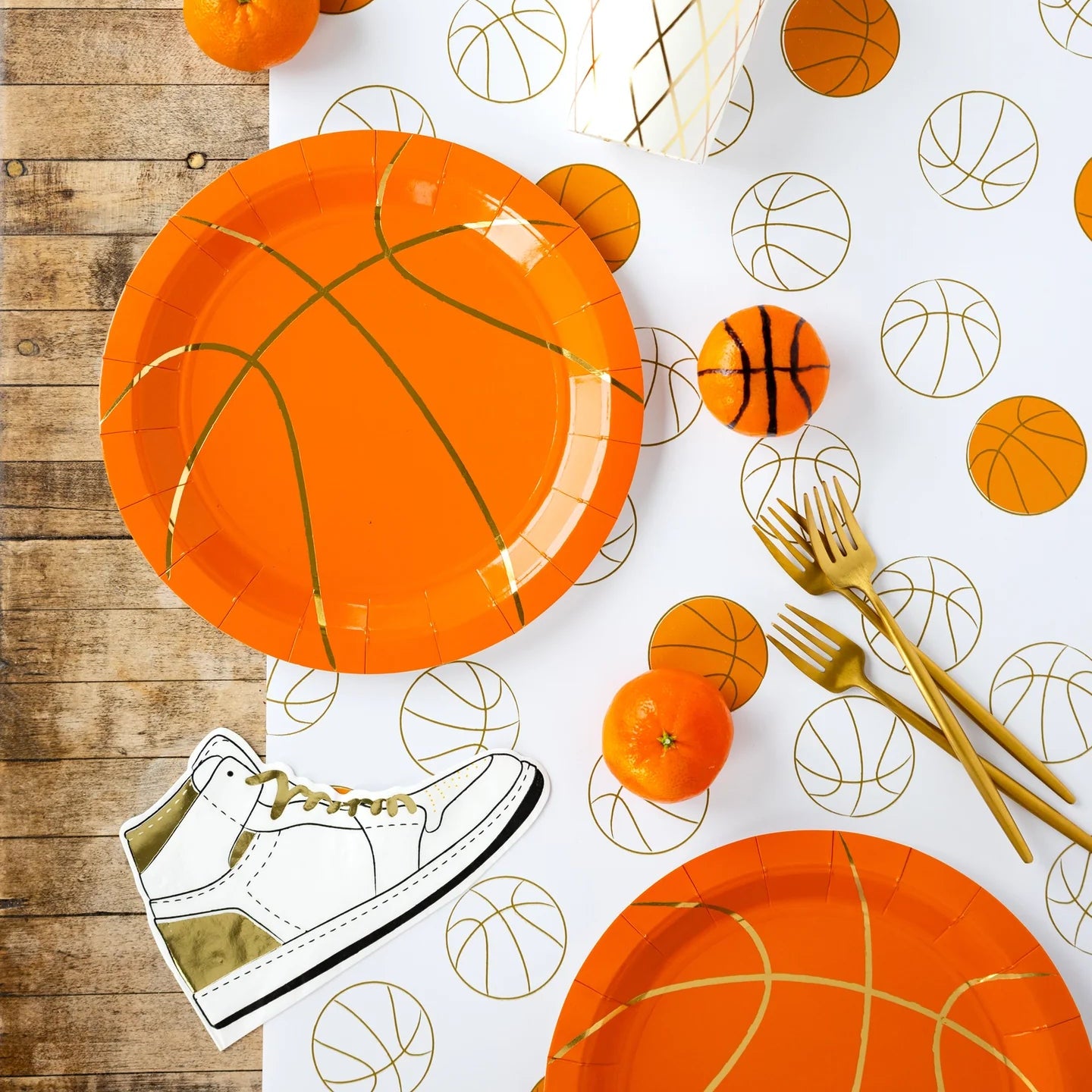 Hoops table spread with oranges and basketball paper plates.