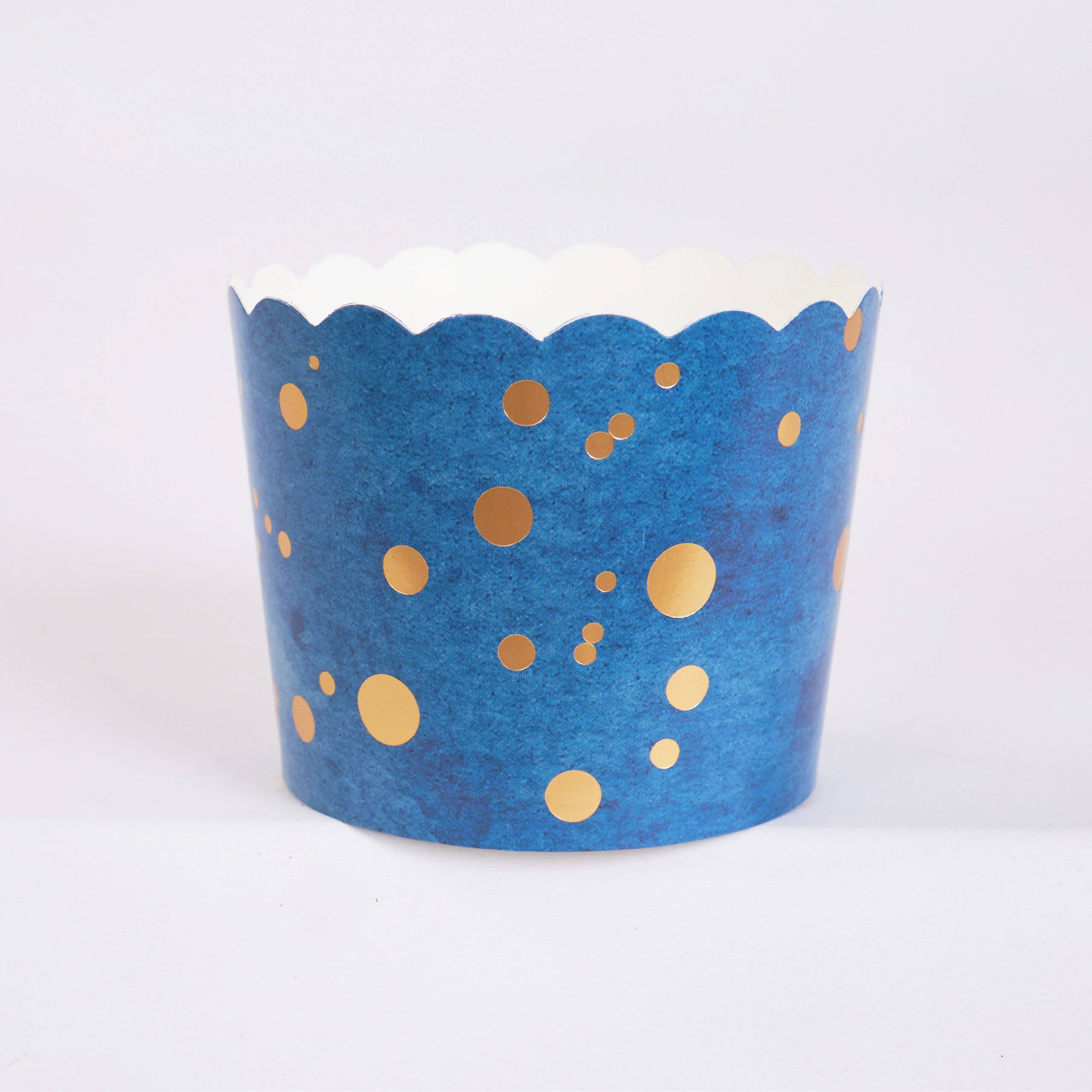 blue cupcake baking cup with gold foil dots and scalloped edge