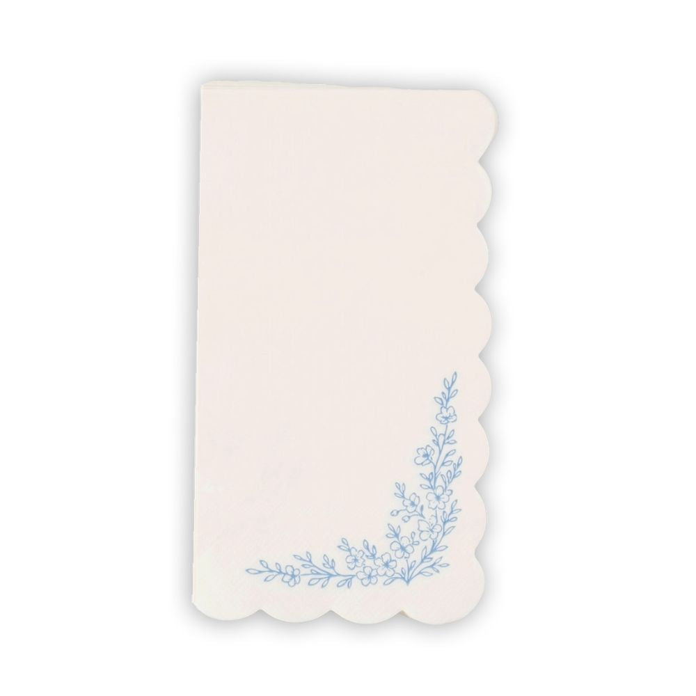 Blue floral paper guest towel with scalloped edge and botanical corner design.
