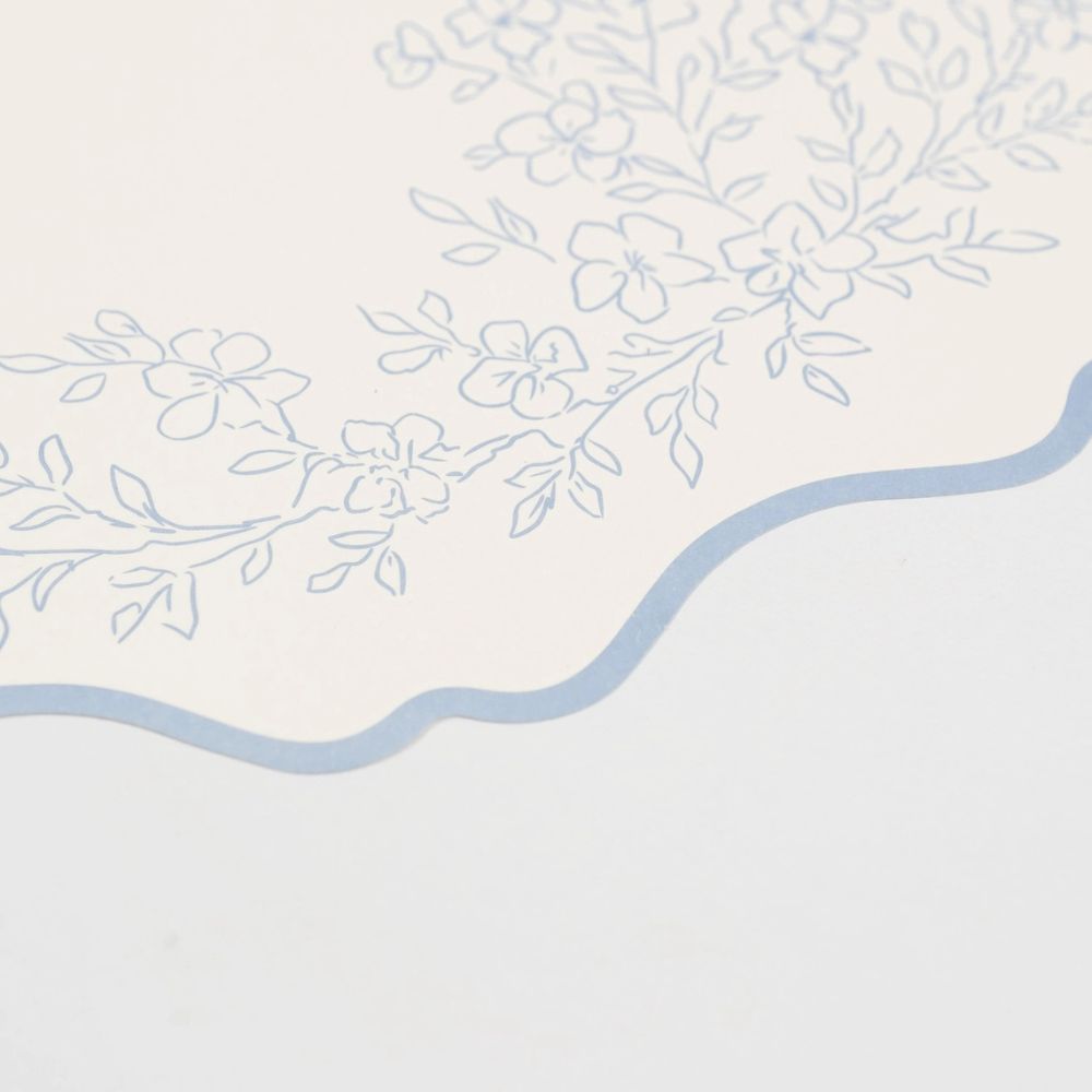 detailed floral illustration on blue paper placemat border.