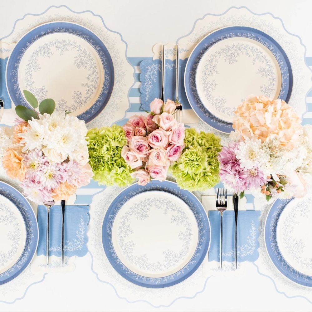coordinated blue tablescape with floral placemats and matching plates.
