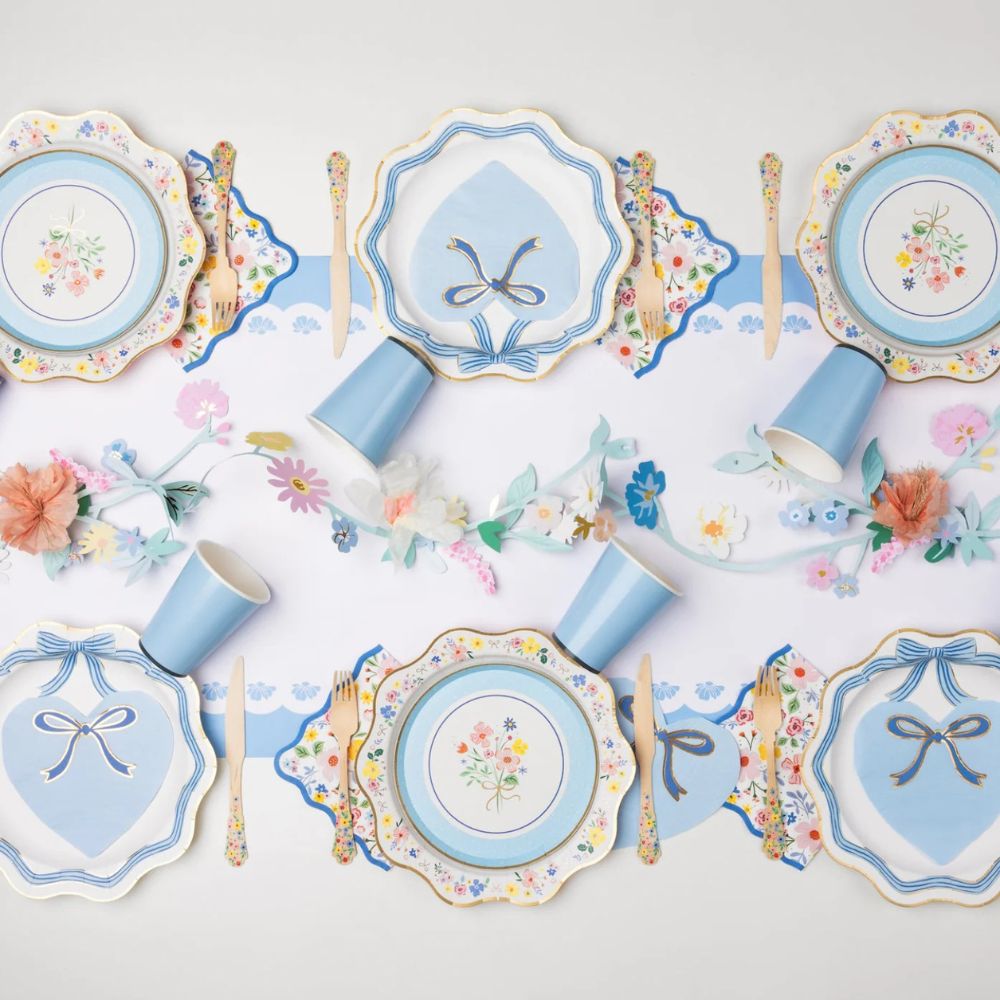 Blue and gold bow dinner plates with floral table setup