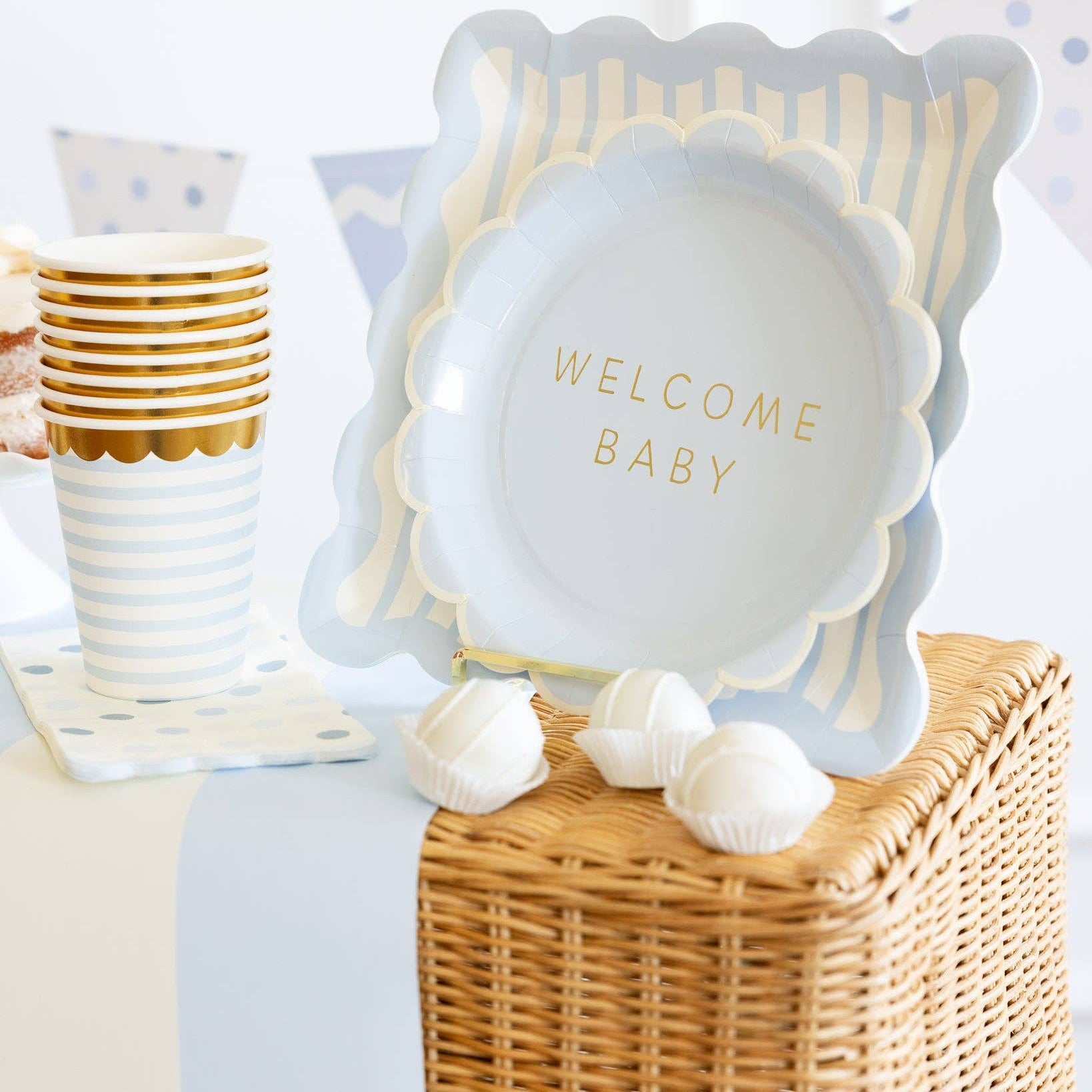 Baby blue polka dot napkins styled with blue baby shower plates and cups