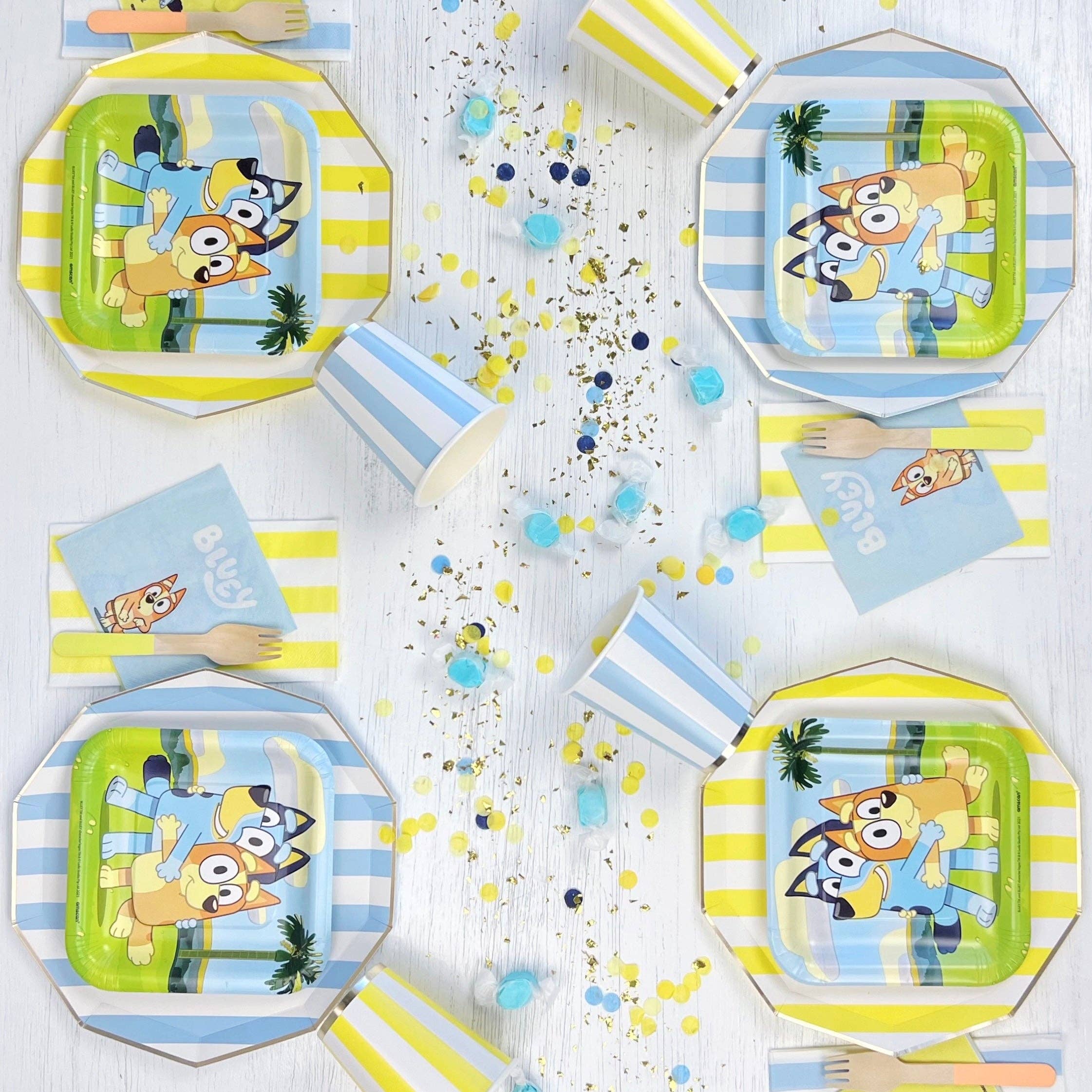 Bluey party table setting with yellow striped guest towels.
