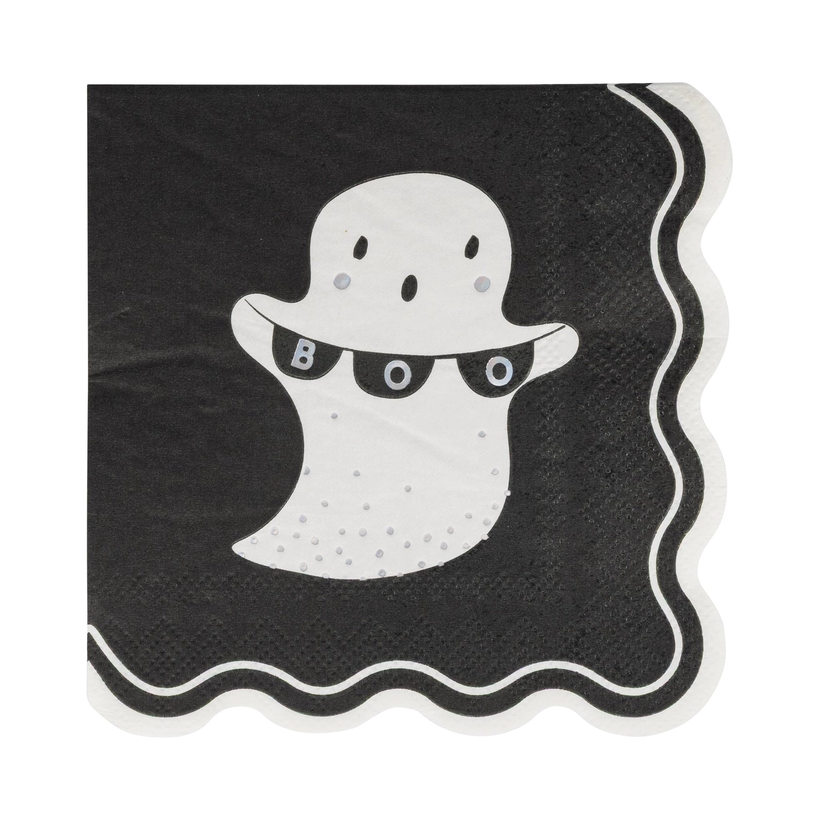 Unfolded 5-inch square cocktail napkin from the kit featuring a white ghost holding a mini “BOO” pennant banner against a deep-black background; triple-layer tissue has a scalloped border outlined in matching white, while subtle holographic foil dots mimic falling confetti. Alt image conveys absorbent construction, playful design, and how the napkin ties the ghost motif together with the coordinating plates and felt banner to simplify Halloween hosting.