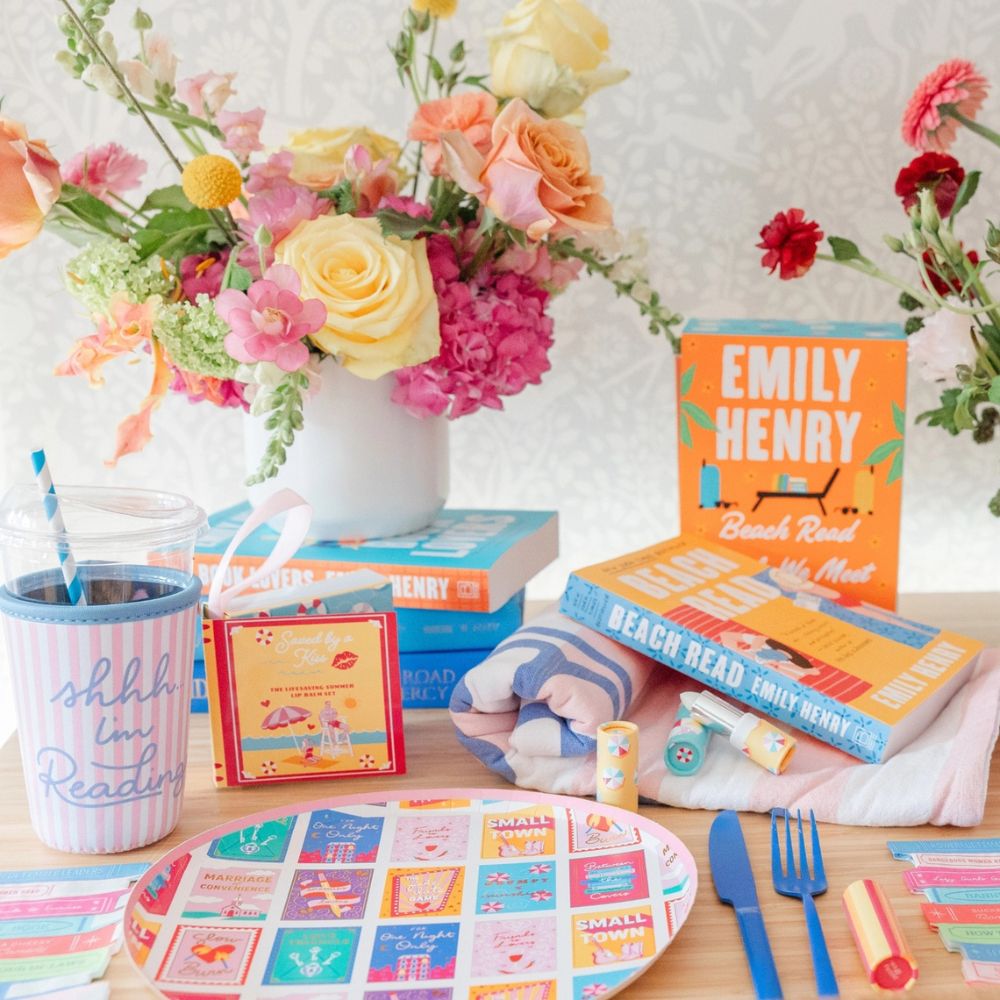 Book themed party table with romcom dinner plates and reading accessories