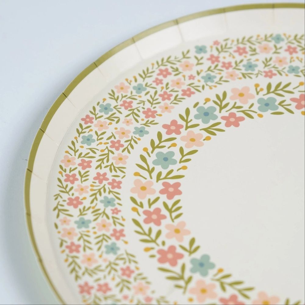 detail of botanical dinner plates showing pastel flower pattern.