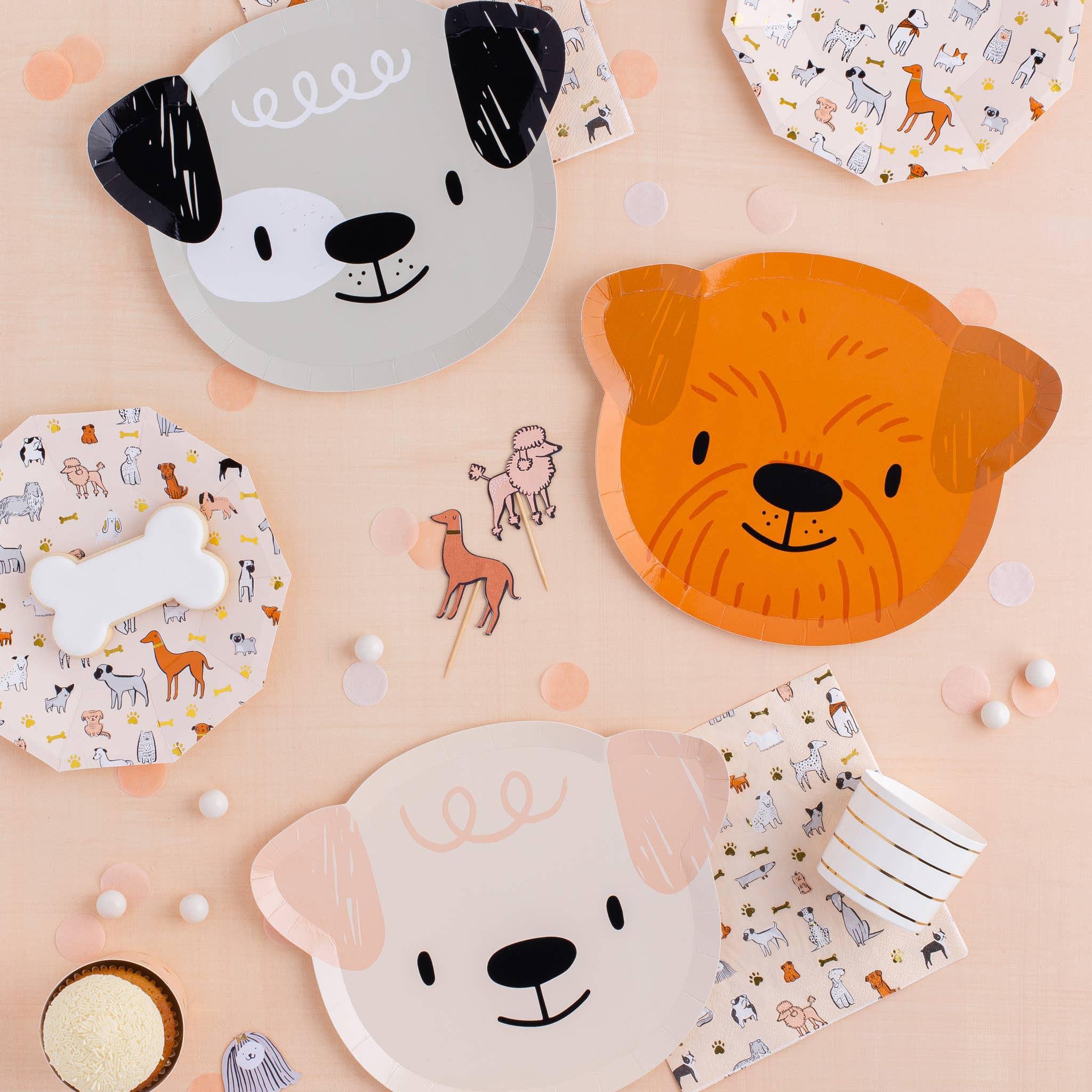 Bow Wow party table with dog plates, napkins, and coordinating cupcake decorations