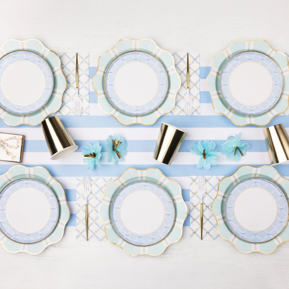 mint and blue party table setting with regency stripe plates and coordinated decor.