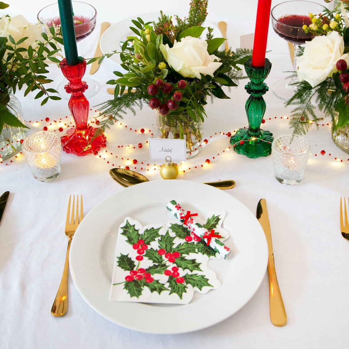 Green glass candle holder on a Christmas table.