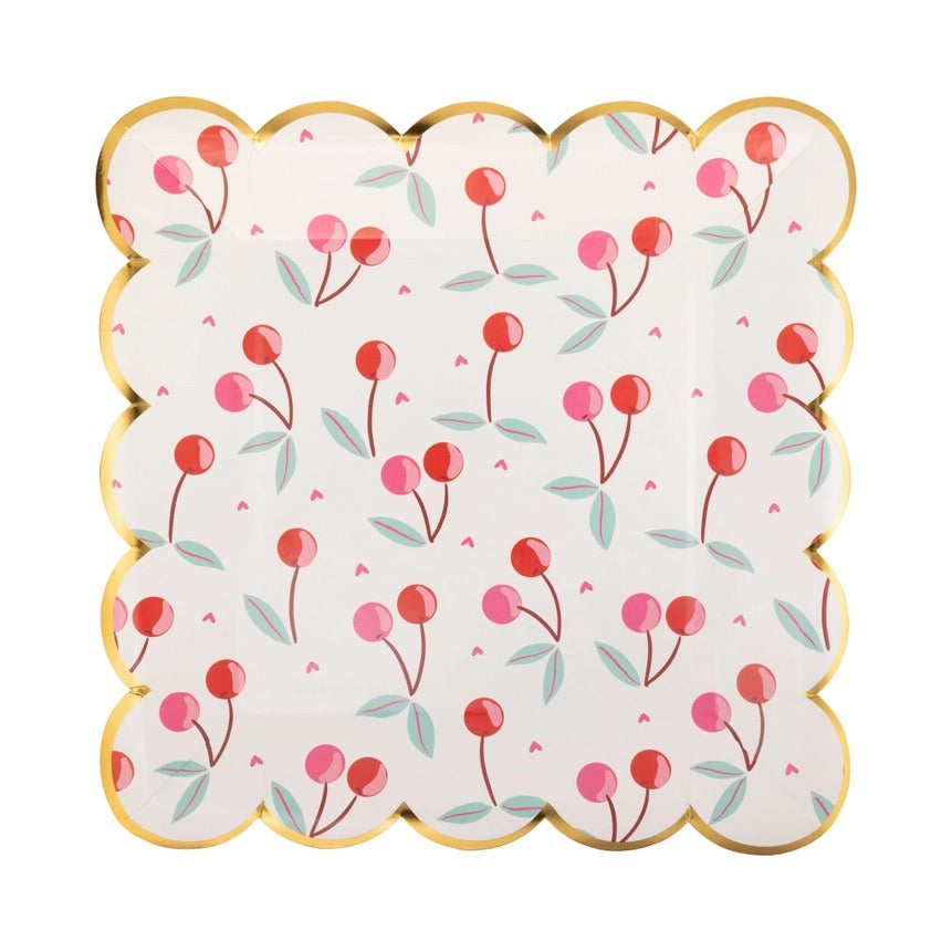 Square scalloped paper plate with colorful red and pink cherries, green leaves, small pink hearts, and gold foil edges, perfect for cherry party decorations.